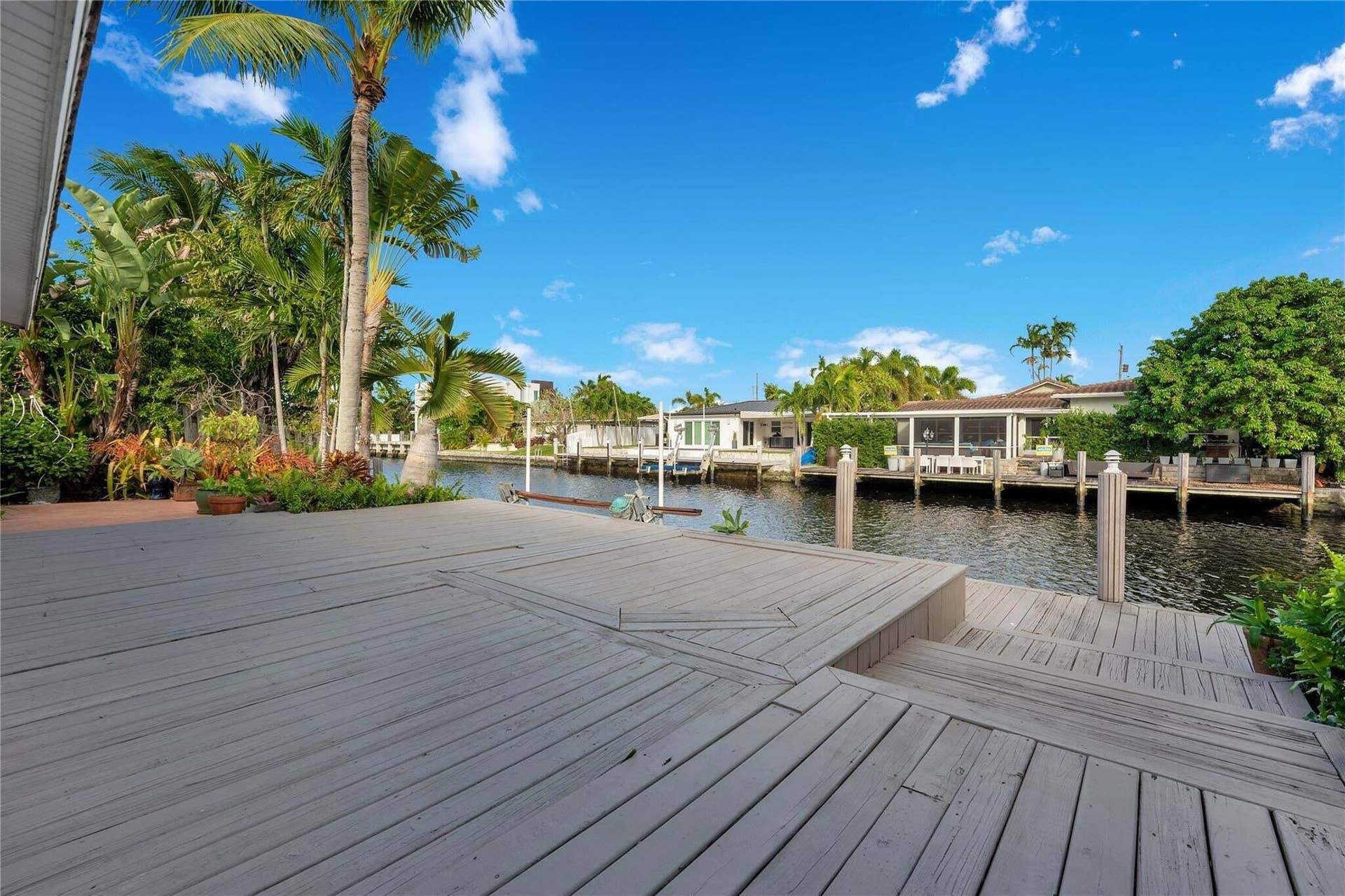 2142 NE 17th Avenue, Wilton Manors, FL 33305 Expansive wooden deck with multi-level design and direct canal access. Two fixed bridges to intercoastal