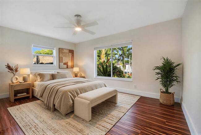 2142 NE 17th Avenue, Wilton Manors, FL 33305 Virtually staged. Rich wood-finish flooring, white walls, and a ceiling fan with integrated lighting