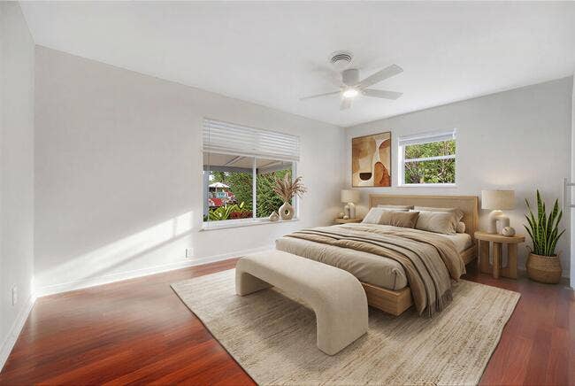 2142 NE 17th Avenue, Wilton Manors, FL 33305 Virtually staged. Wood-finish flooring, white walls, louvered door, modern ceiling fan, and white trim