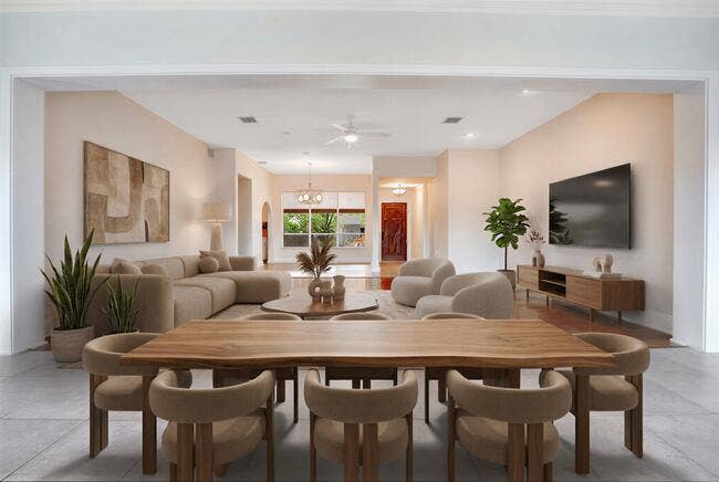 2142 NE 17th Avenue, Wilton Manors, FL 33305 Virtually Staged. Great Room featuring expansive windows, tile flooring, white brick-finish walls, and a track lighting fixture