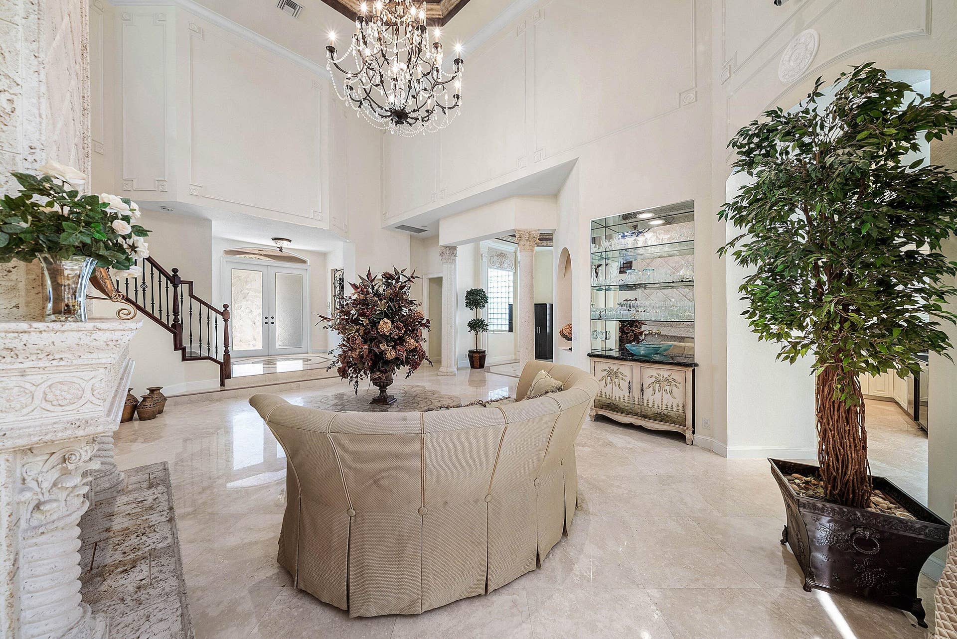Soaring ceilings with decorative molding, marble flooring.