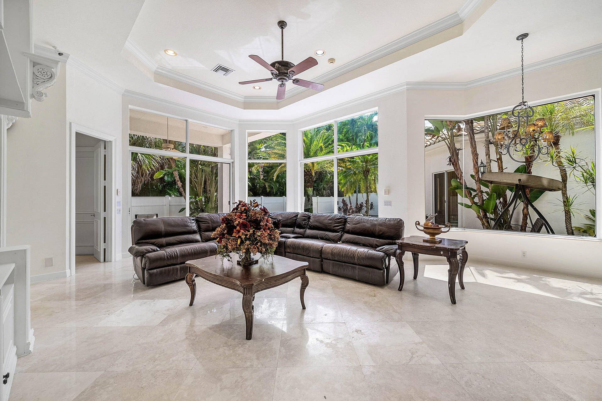 Expansive living space - walls of windows for natural light, marble flooring