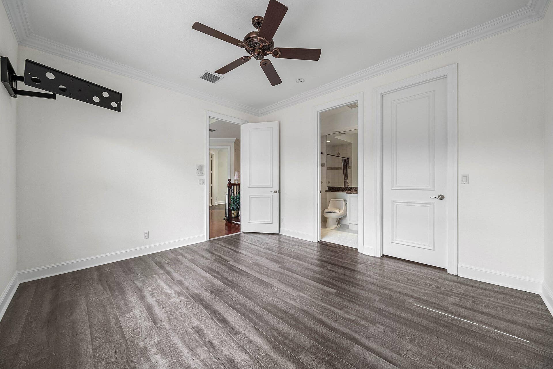 En-Suite bedroom #3 with wood-finish flooring throughout, crown molding, and a ceiling fan