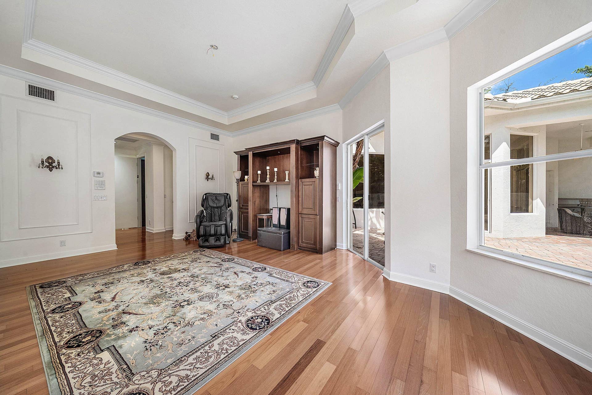 Engineered Hardwood flooring, crown molding, tray ceiling - slider access out to pool area