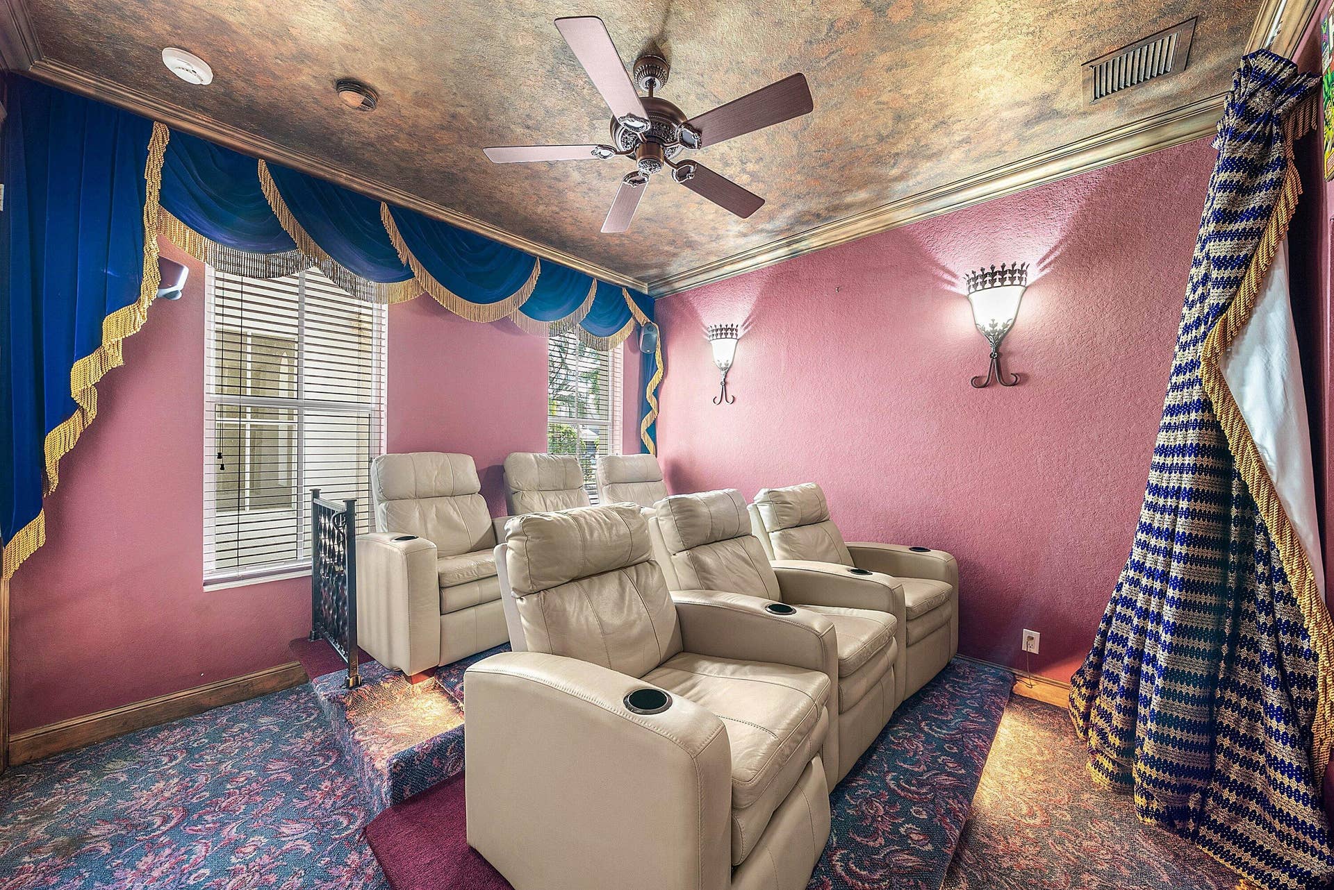 Tiered seating with wall sconces, ceiling fan