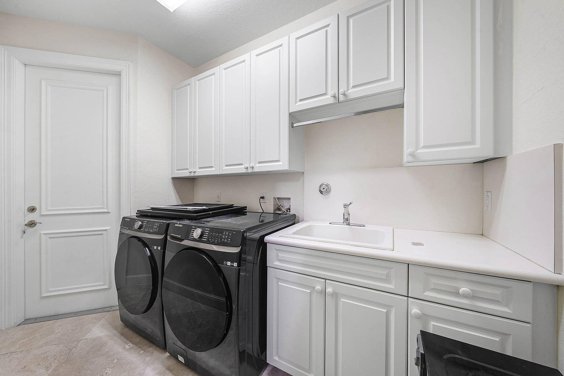 Laundry Room with ample storage, access to 2 car main garage
