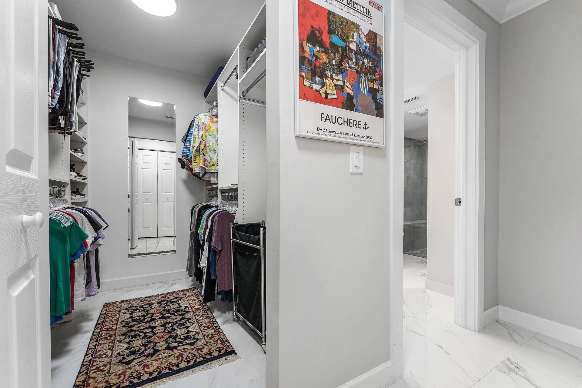 12 Stratford Drive E, #A, Boynton Beach, FL 33436 Walk-in closet with built-in shelving, hanging rods, full-length mirror, and white panel doors