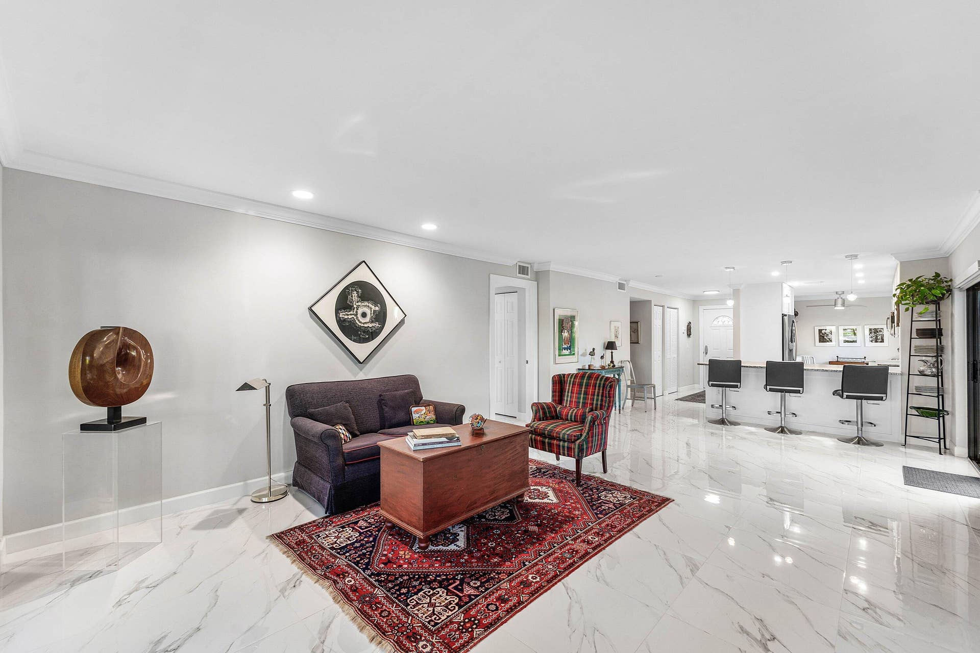 12 Stratford Drive E, #A, Boynton Beach, FL 33436 Recessed lighting, crown molding, and light-toned walls complement the polished tile flooring