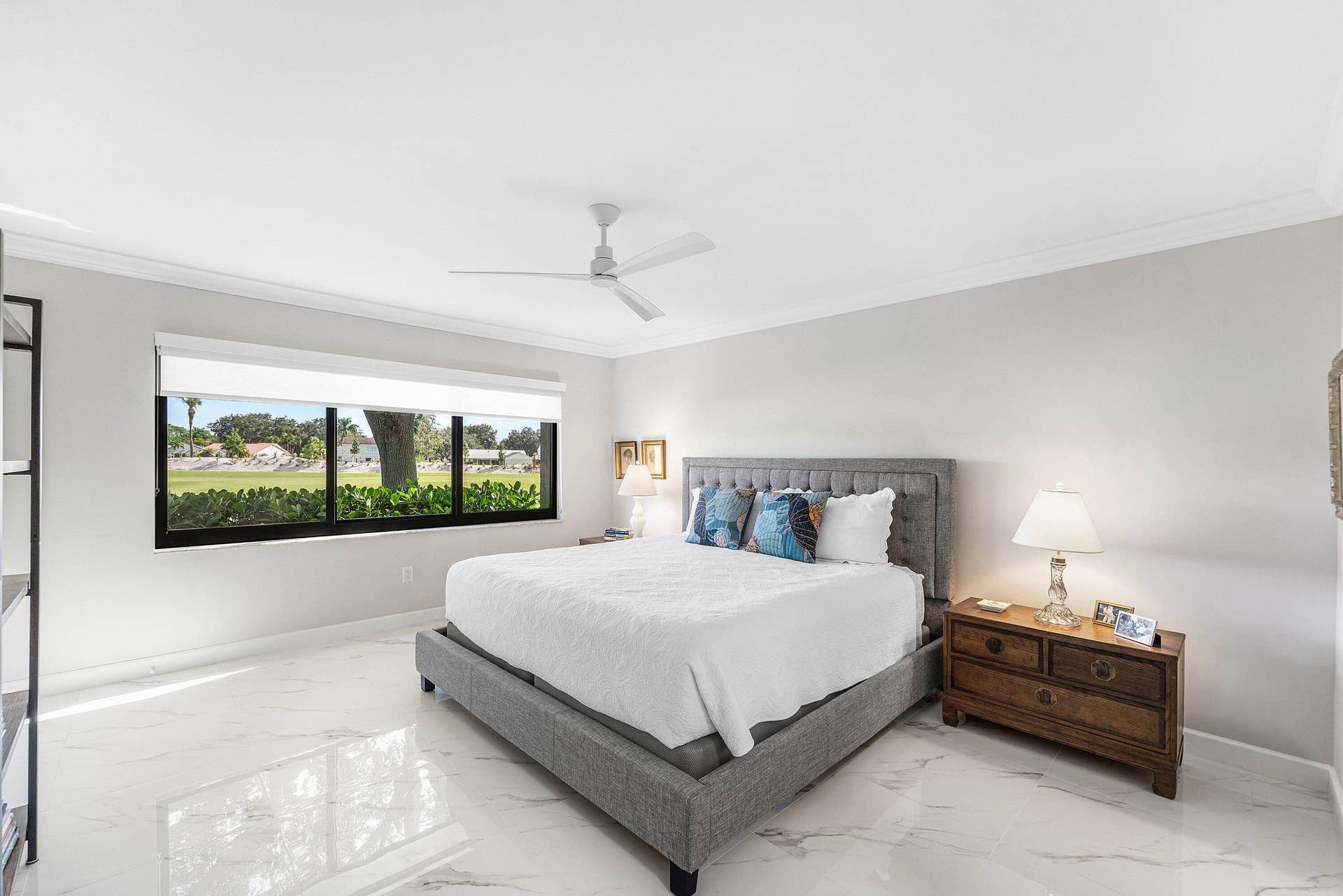 12 Stratford Drive E, #A, Boynton Beach, FL 33436 White tile flooring, expansive window with exterior scenery, crown molding, and a ceiling fan