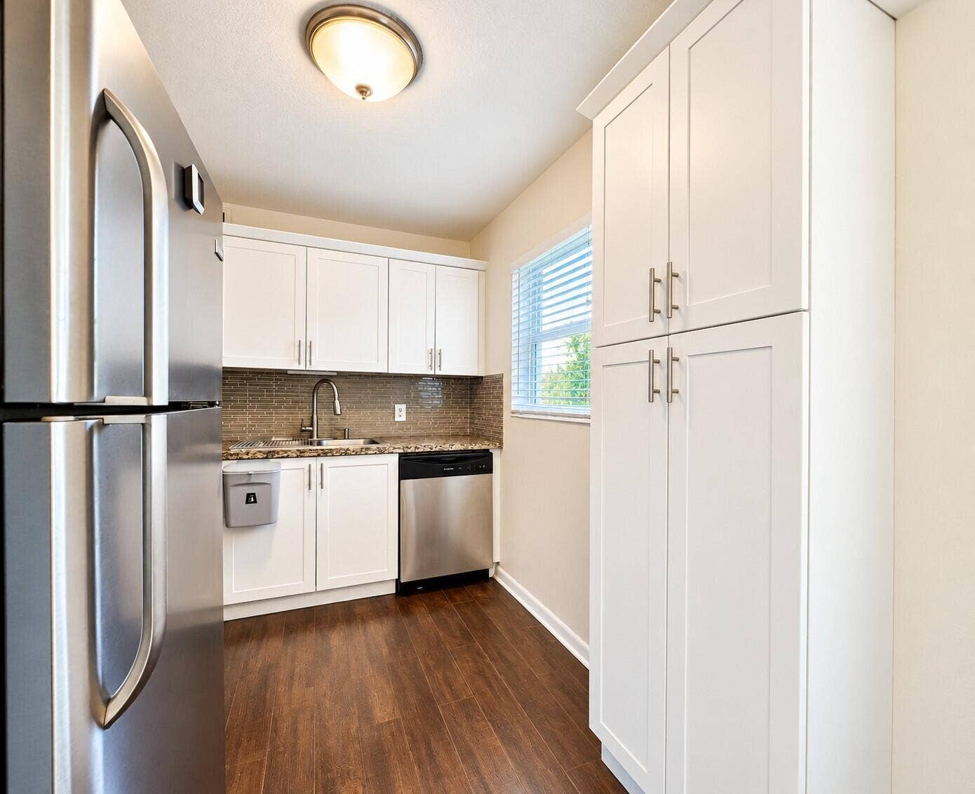Beautifully Updated Kitchen With White Shaker Style Cabinets, New Stainless Appliances, and Window for Natural Light & Water Views