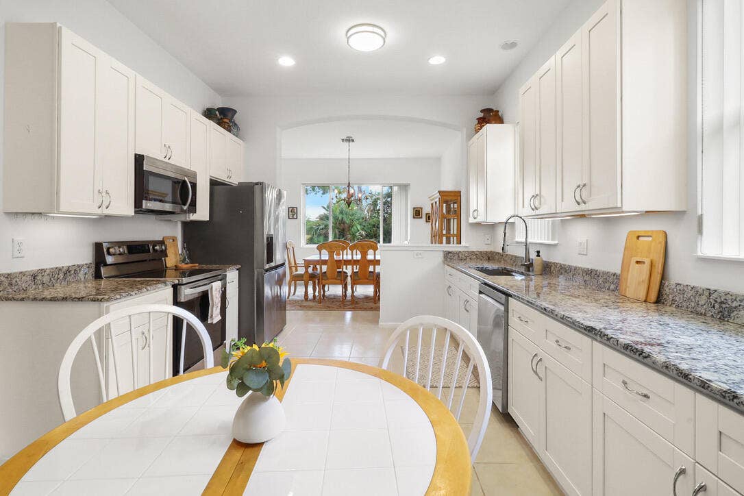 9110 Bay Harbour Circle, West Palm Beach, FL 33411 Modern kitchen with white cabinets
