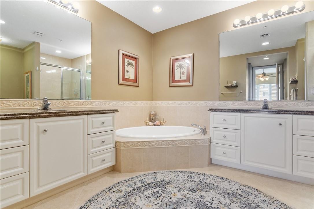 Primary suite has dual vanities, large soaking tub, and a walk-in shower.