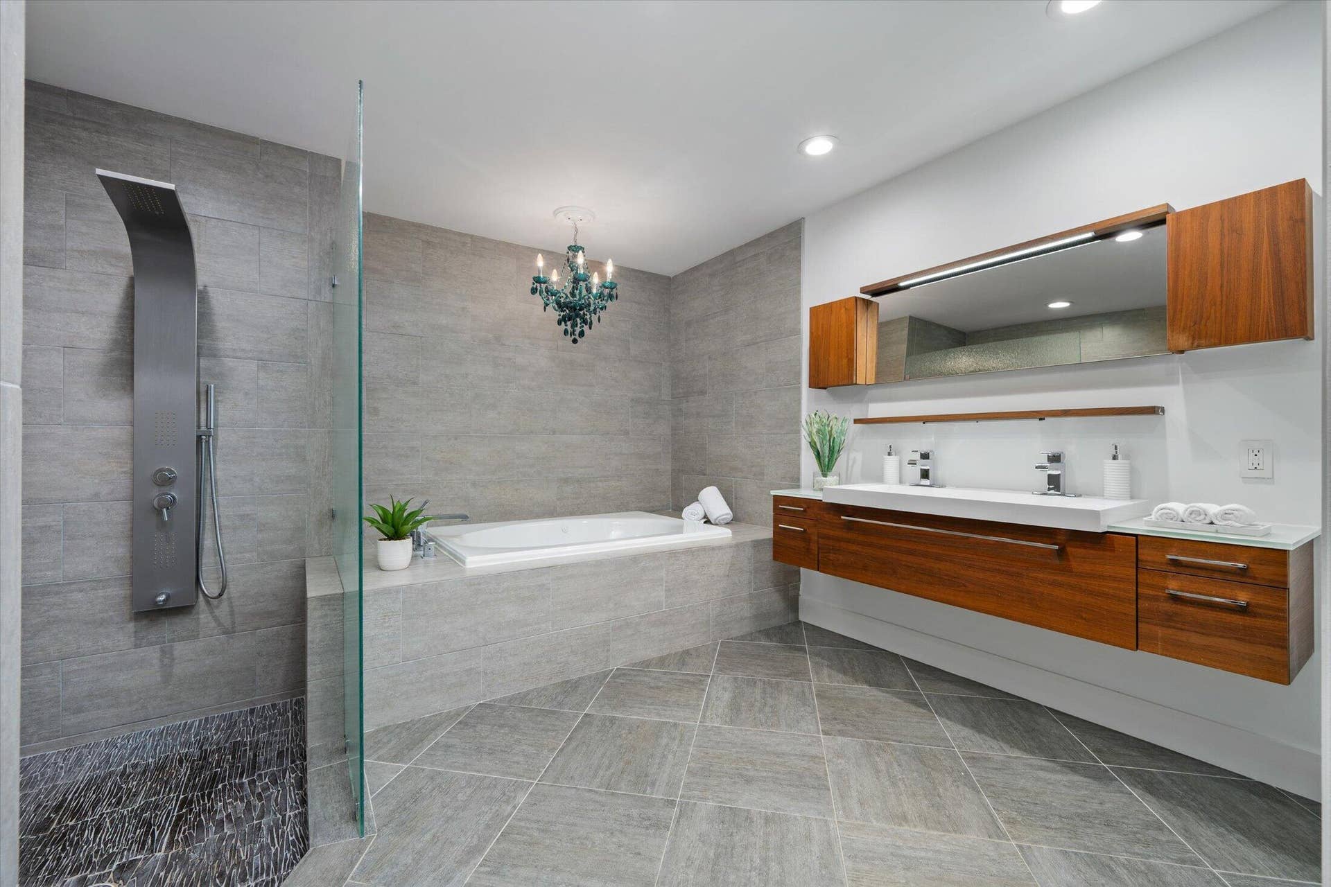 2890 ANTIETAM Lane, West Palm Beach, FL 33409 Integrated shower panel, large soaking tub, dual floating vanity with integrated sinks, wood-finish cabinetry, and recessed lighting