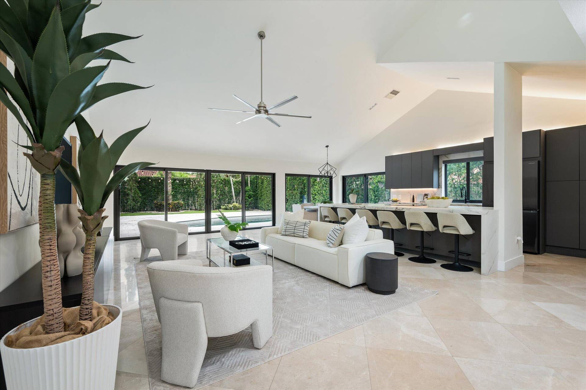 2890 ANTIETAM Lane, West Palm Beach, FL 33409 Vaulted ceilings, large format tile flooring, built-in kitchen cabinetry, and expansive glass doors