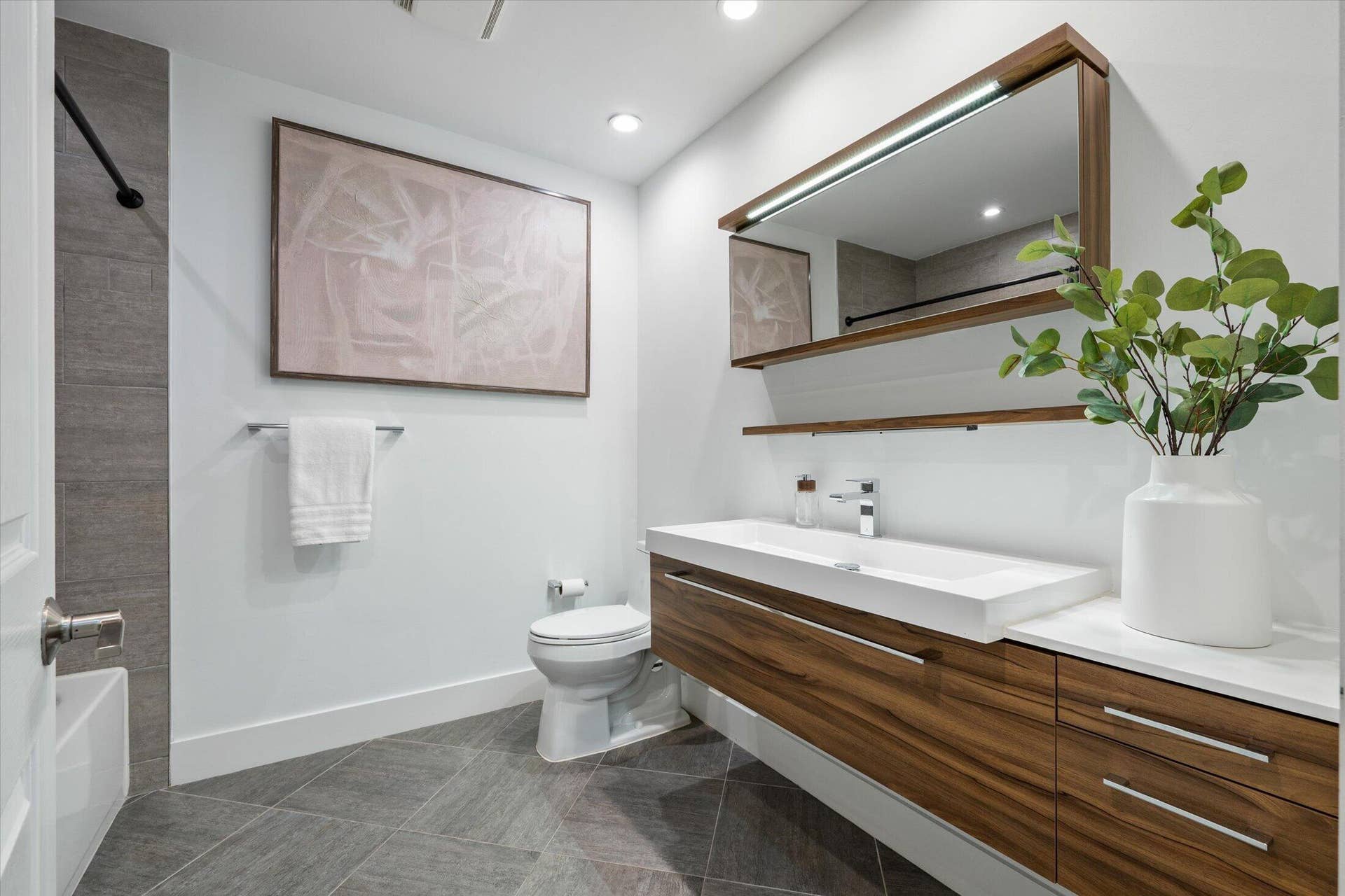 2890 ANTIETAM Lane, West Palm Beach, FL 33409 Integrated vanity with wood-finish cabinetry, white countertop, and rectangular undermount sink