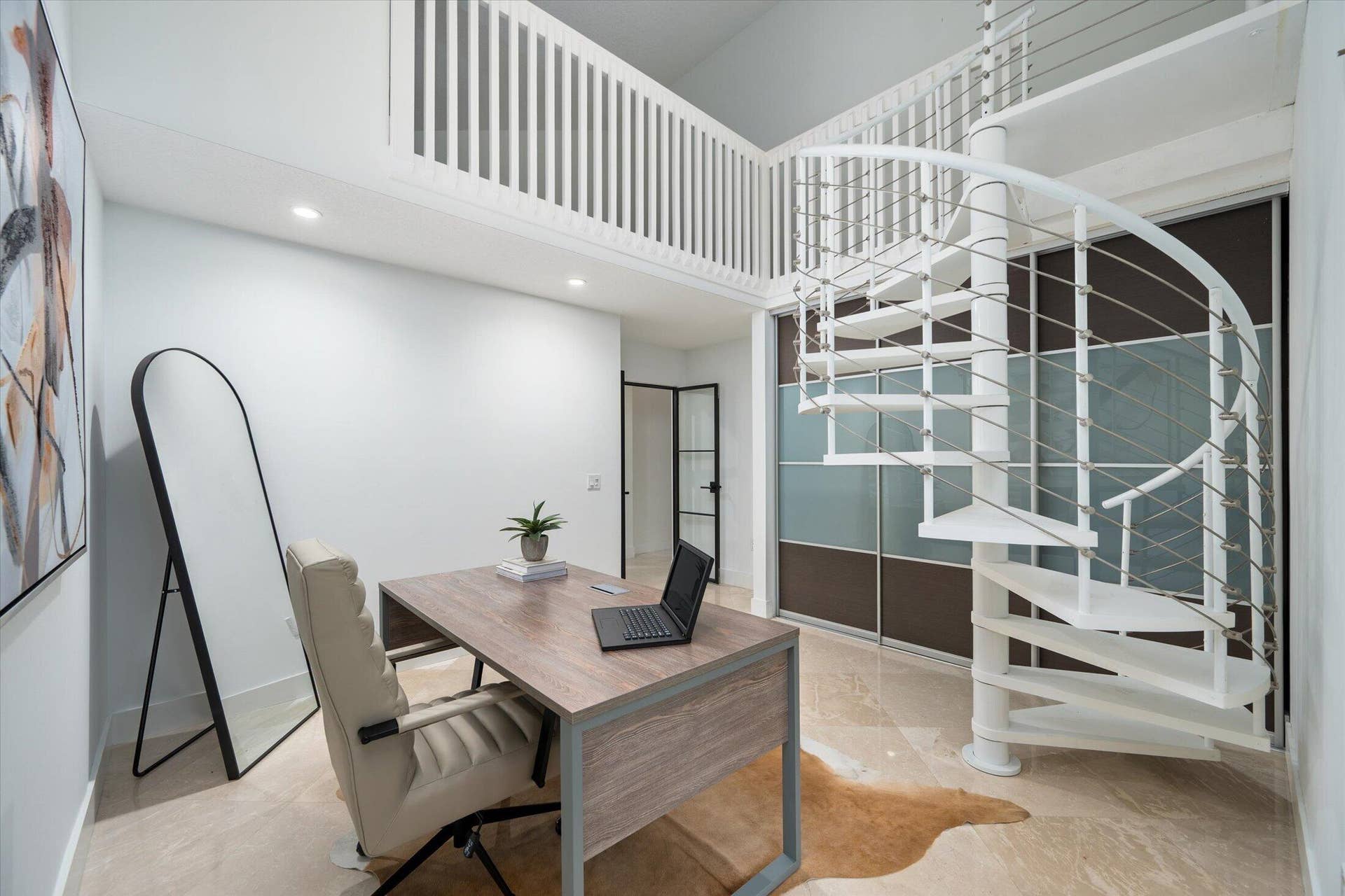 2890 ANTIETAM Lane, West Palm Beach, FL 33409 White spiral staircase with cable railings, offering access to a loft space with a white slatted railing