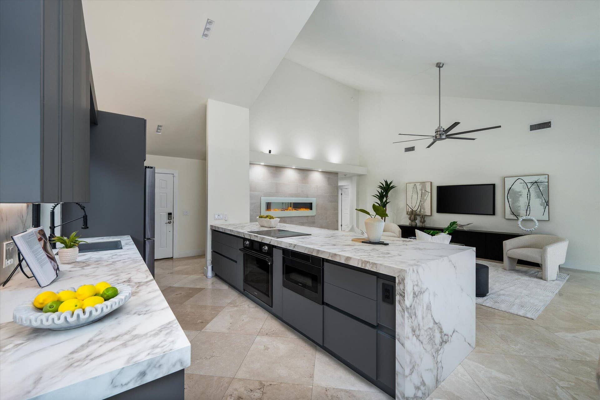 2890 ANTIETAM Lane, West Palm Beach, FL 33409 Spacious living area featuring vaulted ceilings, a modern ceiling fan, and light-toned tile flooring