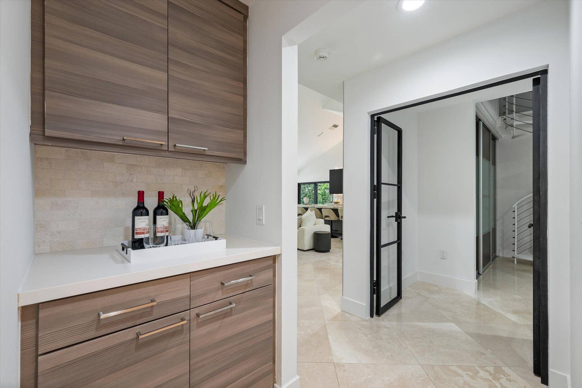 2890 ANTIETAM Lane, West Palm Beach, FL 33409 Built-in cabinetry with wood-finish fronts, light-toned countertop, and tiled backsplash