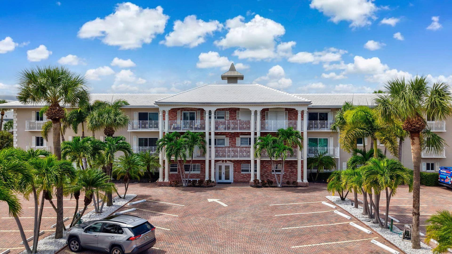 1198 Hillsboro Mile, #210, Hillsboro Beach, FL 33062 Multi-story building featuring balconies, brick facade, and a cupola