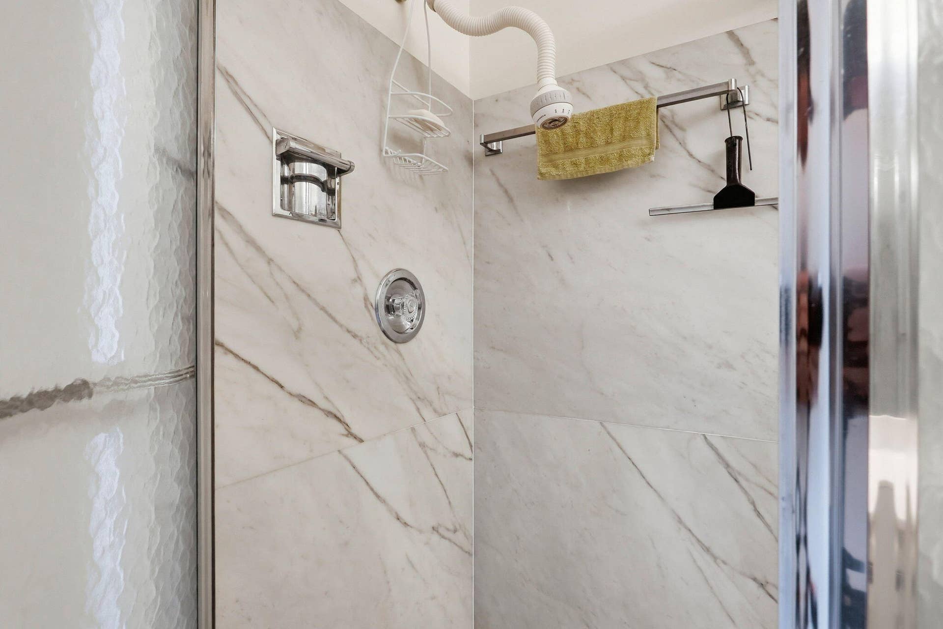 1198 Hillsboro Mile, #210, Hillsboro Beach, FL 33062 Shower enclosure featuring marble-look wall tiling and a chrome shower fixture