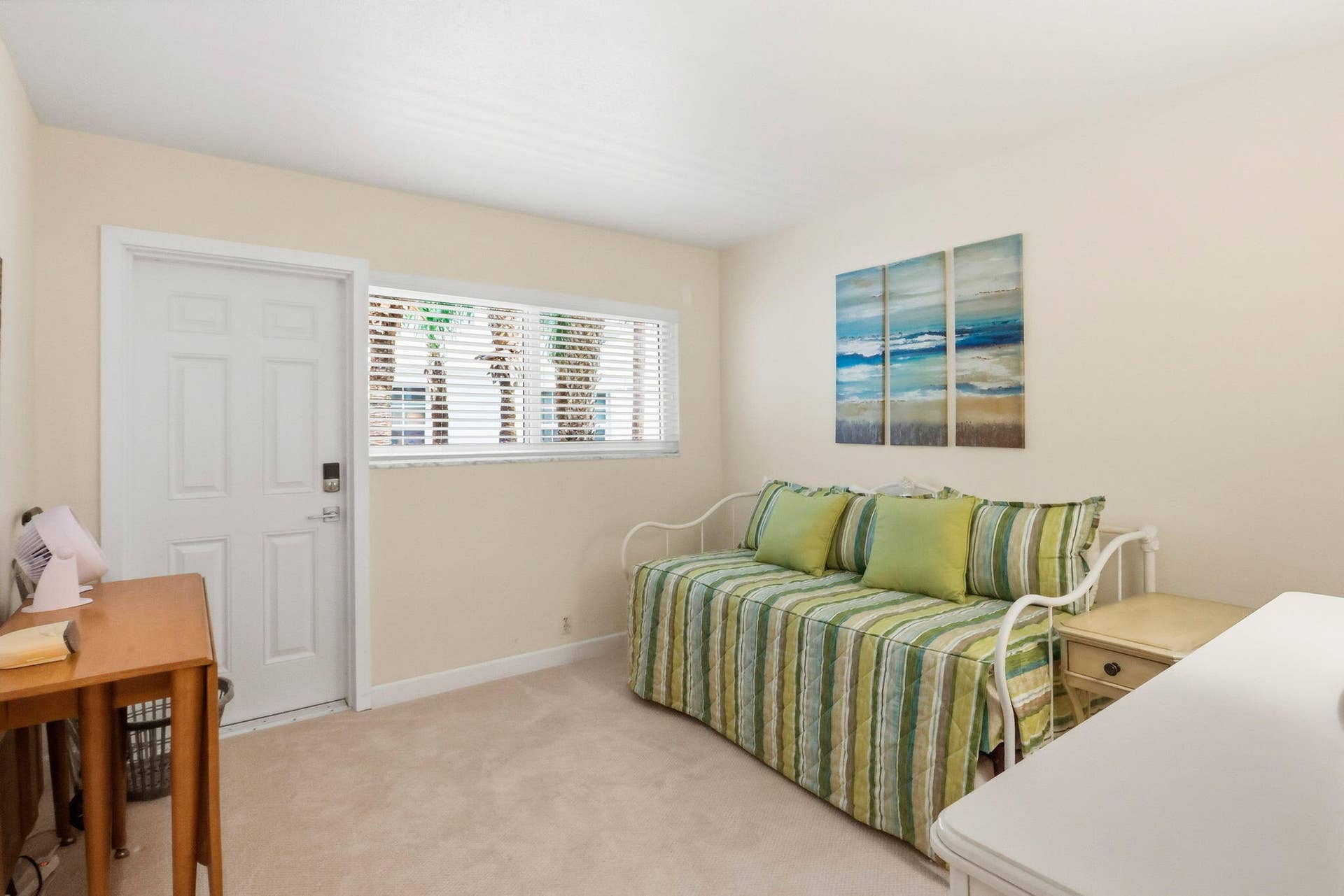 1198 Hillsboro Mile, #210, Hillsboro Beach, FL 33062 Carpeted room with a white paneled door, horizontal window with blinds, and neutral wall paint