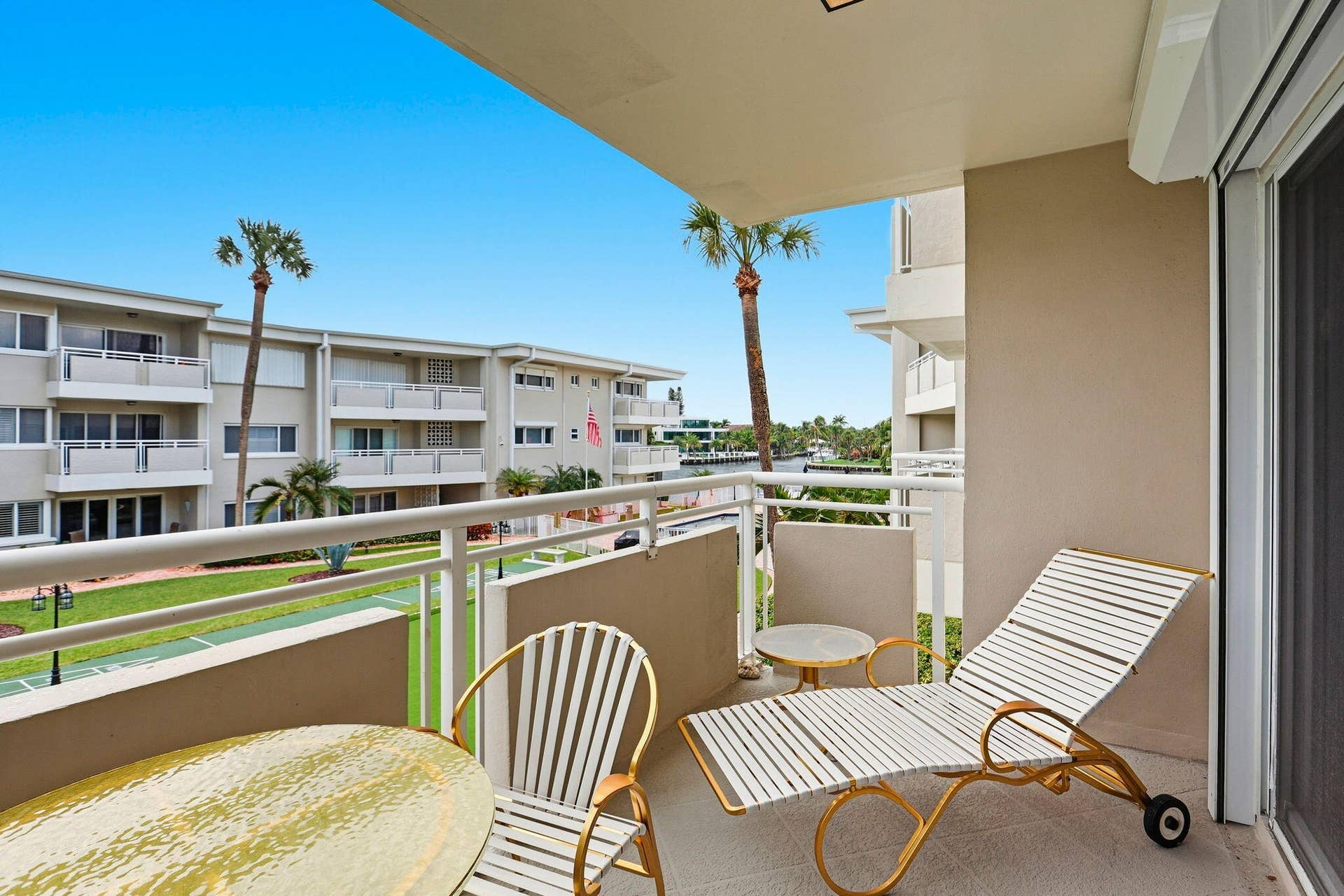 1198 Hillsboro Mile, #210, Hillsboro Beach, FL 33062 Private balcony with a smooth concrete floor, white metal railing, and a sliding glass door