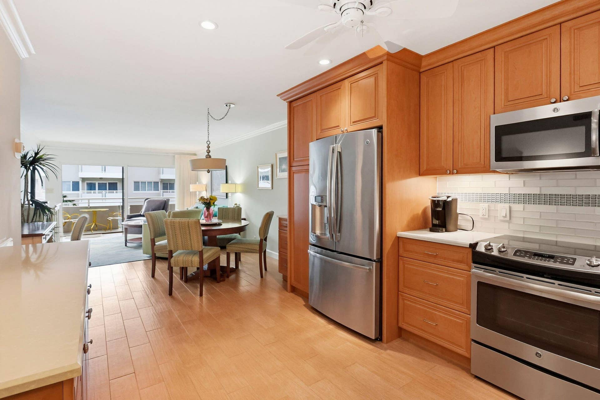 1198 Hillsboro Mile, #210, Hillsboro Beach, FL 33062 Kitchen featuring stainless steel appliances, wood-finish cabinetry, light countertops, and subway tile backsplash
