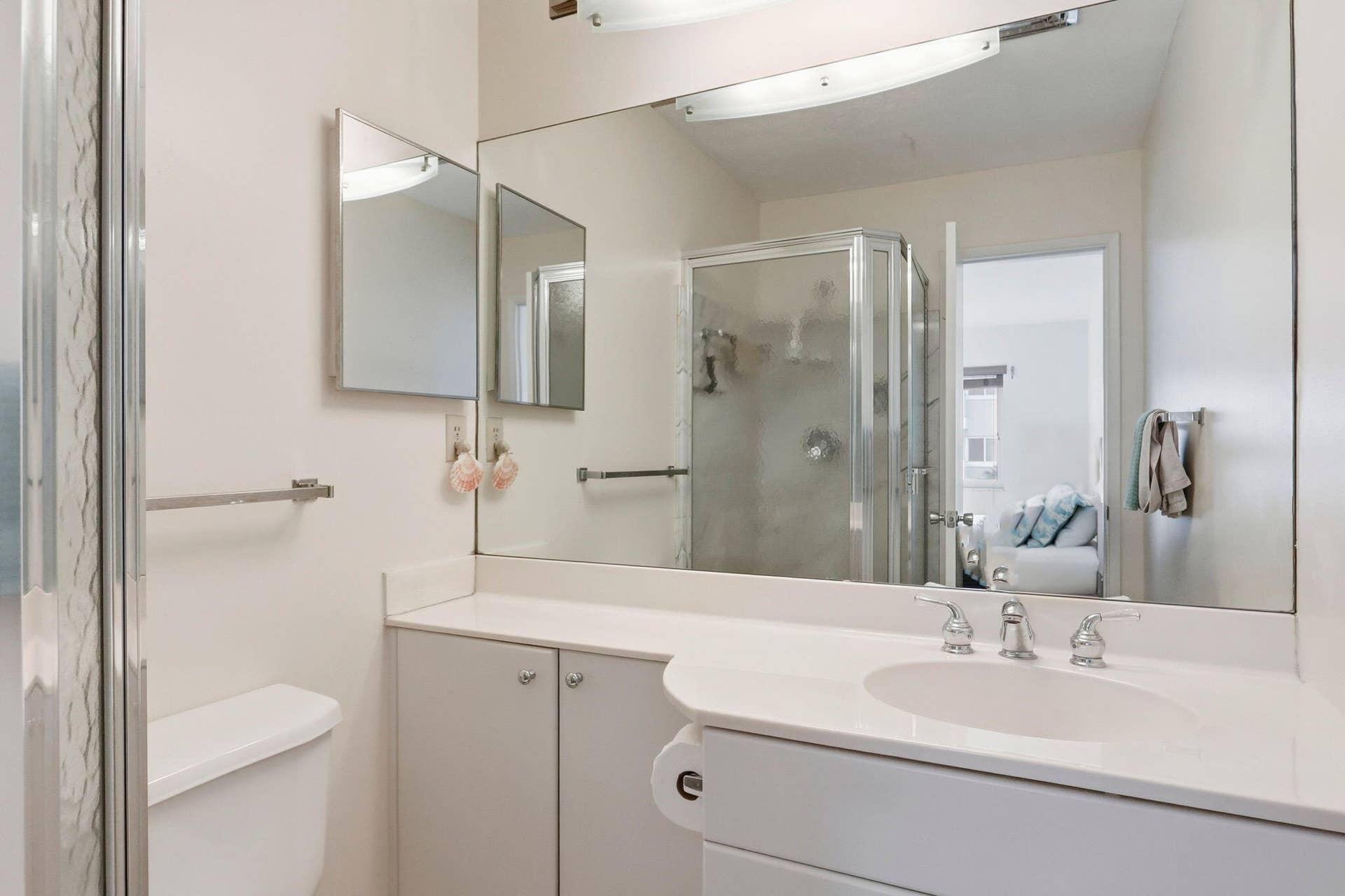 1198 Hillsboro Mile, #210, Hillsboro Beach, FL 33062 White vanity with integrated sink, chrome faucet, and expansive wall-mounted mirror
