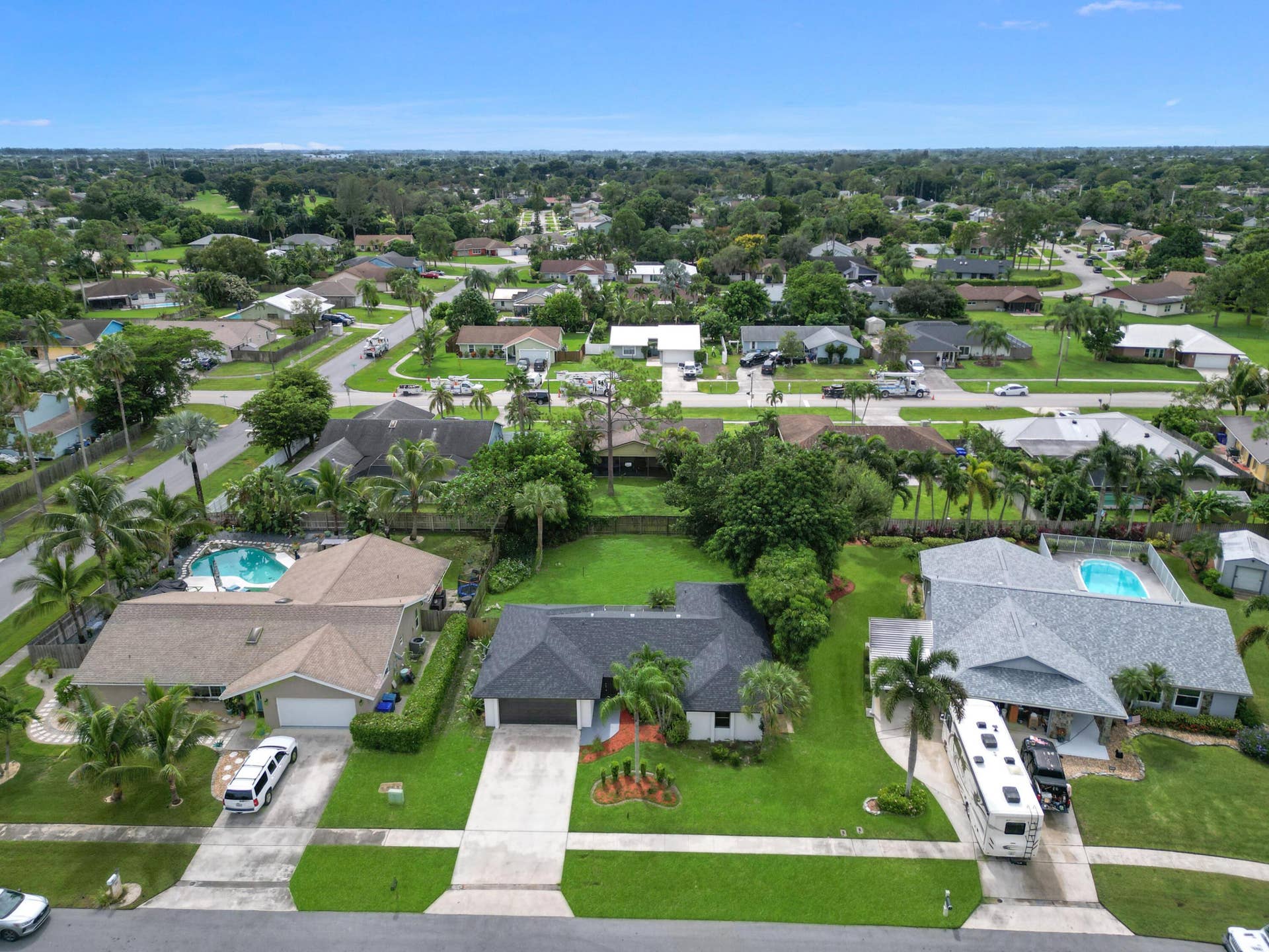 Single-story residence featuring a dark shingle roof, attached two-car garage, and a concrete driveway