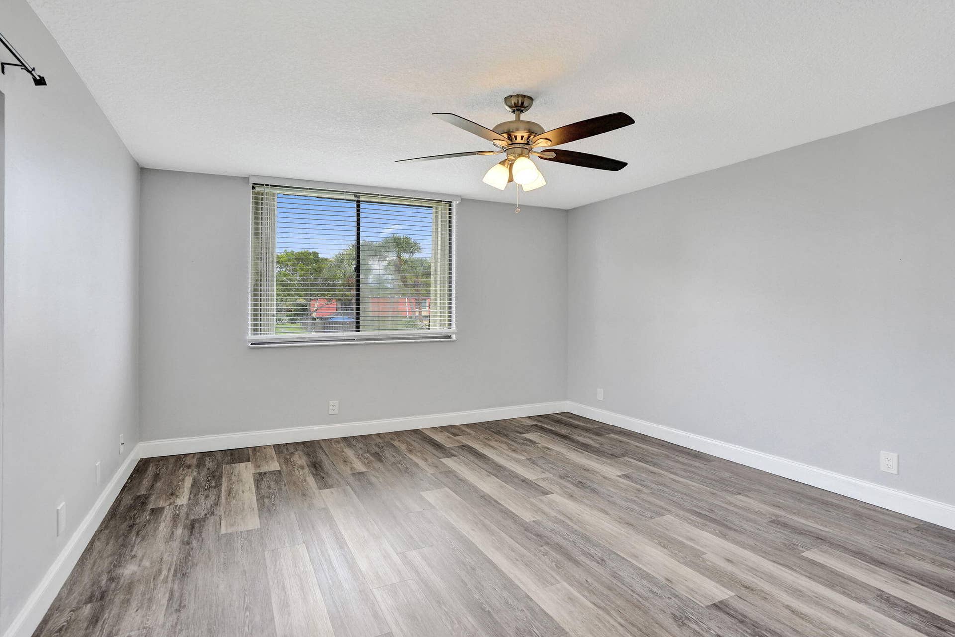 Wood-finish flooring , ceiling fan and plenty of natural light