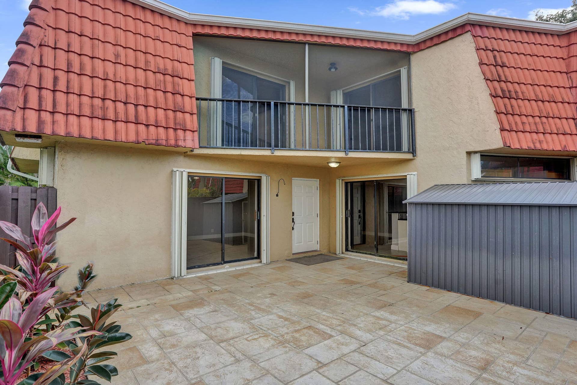 Ground-level patio with textured pavers, perfect for pets