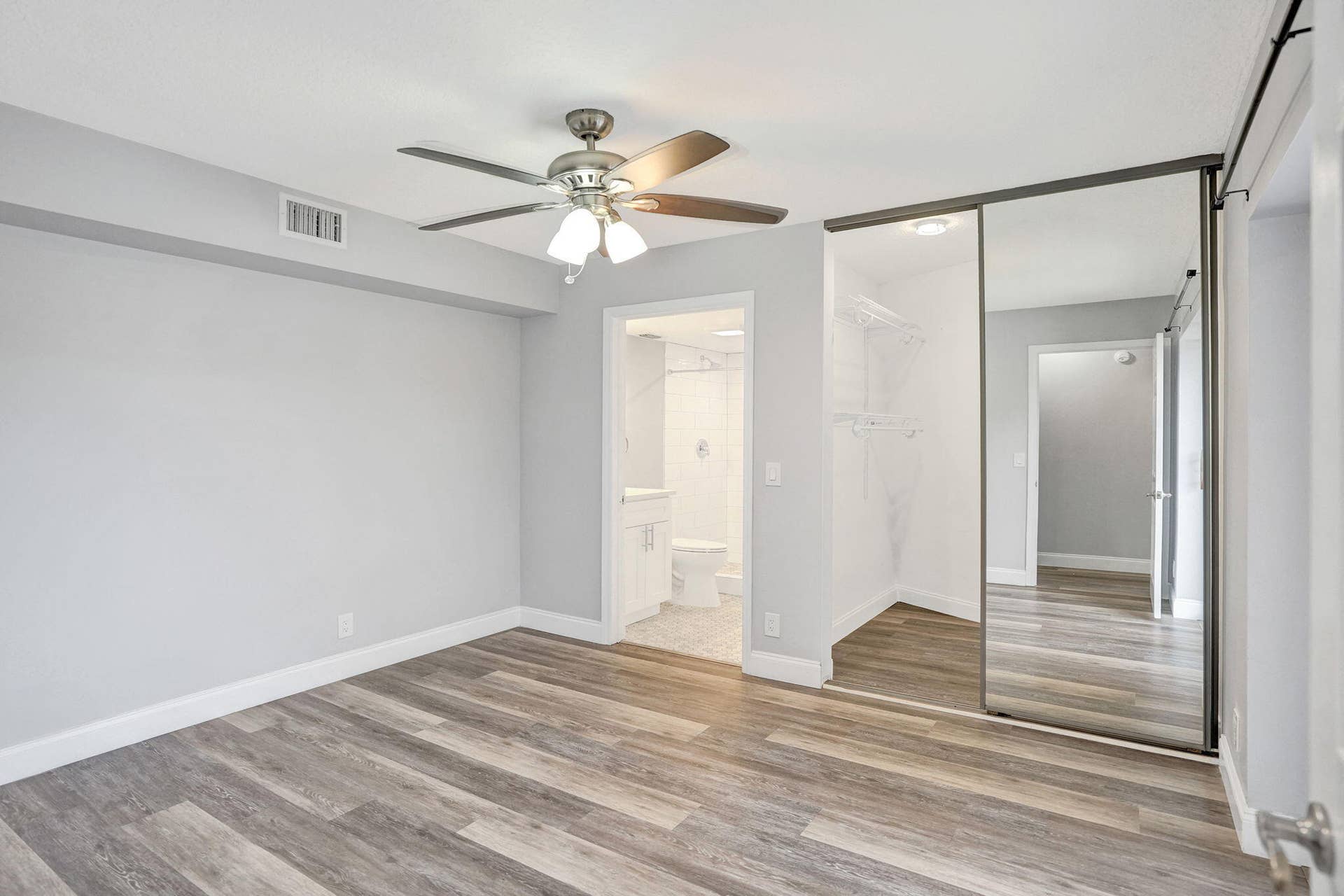 Wood-finish flooring, and mirrored closet doors,