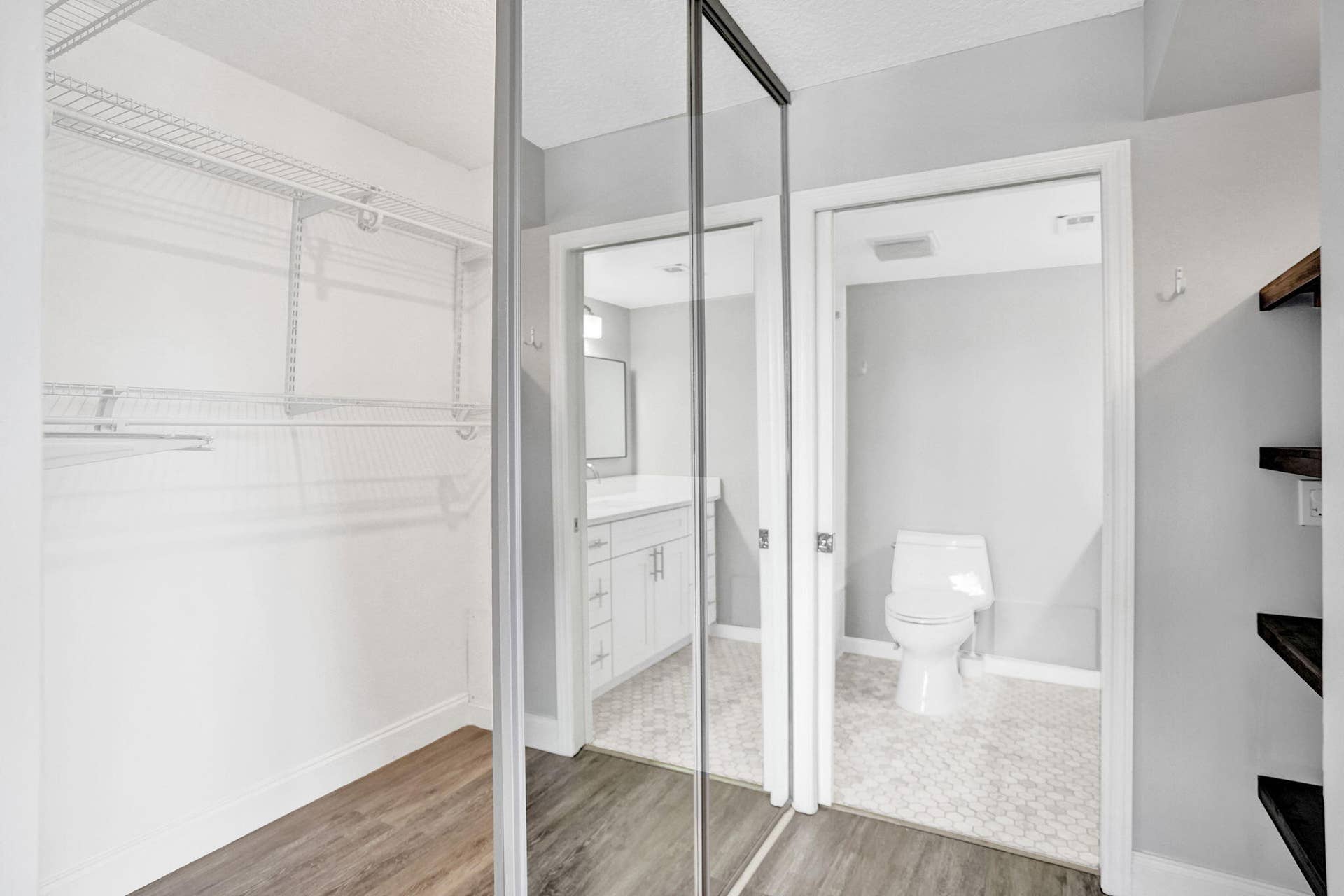 Mirrored closet doors and open wood shelving