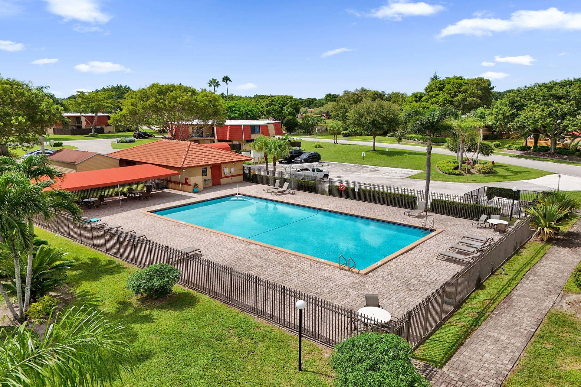 Community swimming pool and covered patio seating
