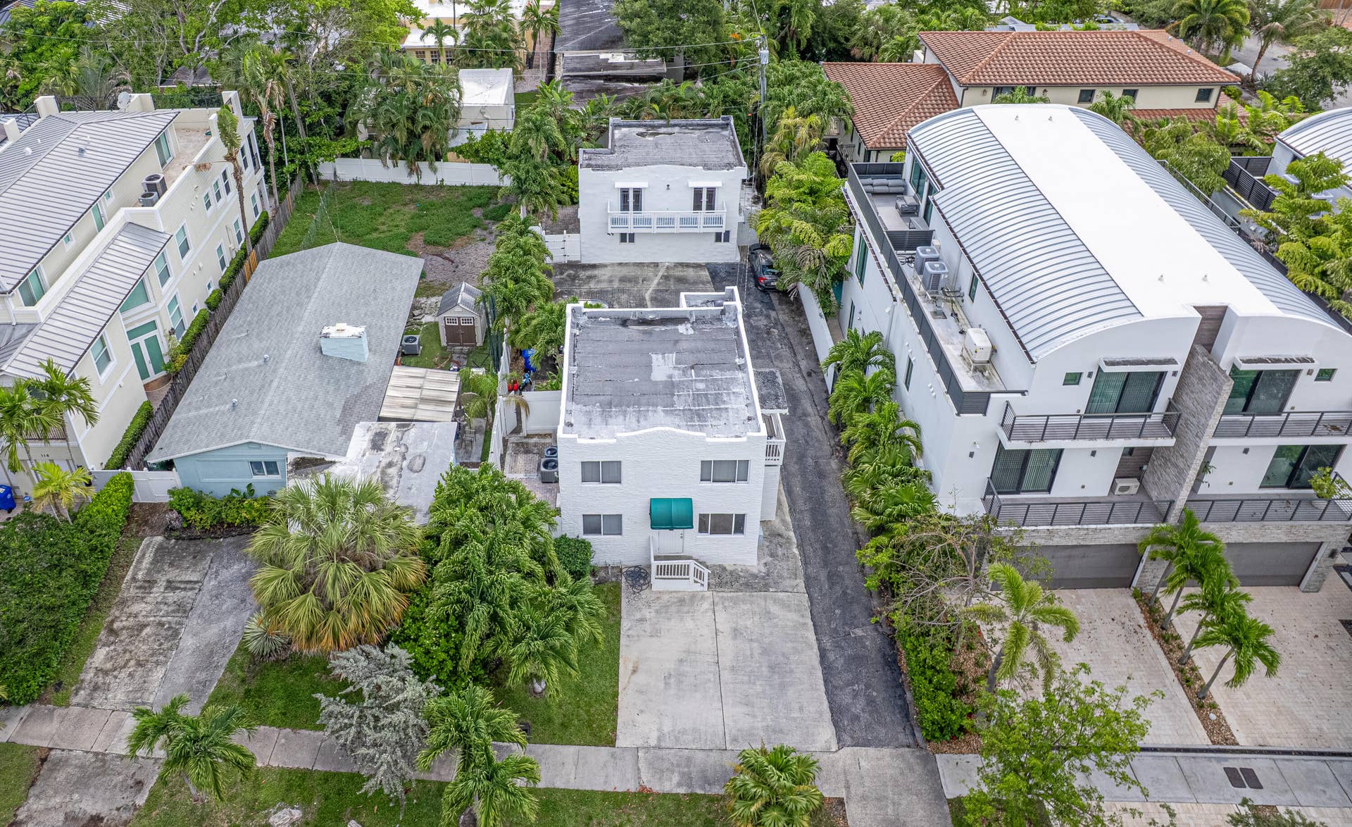 110 NE 16th Terrace, #1-3, Fort Lauderdale, FL 33301 Aerial shows the two building. Single family is behind the front building with the green awning. It is accessed on the south side with a driveway entry.