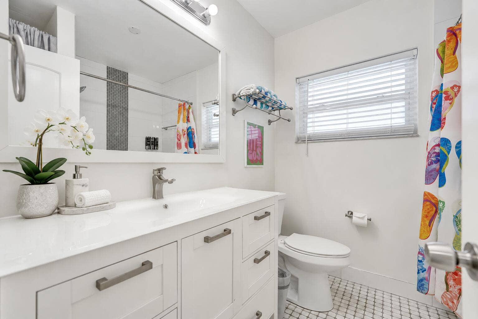 White vanity with a single basin sink, brushed nickel faucet, and integrated countertop