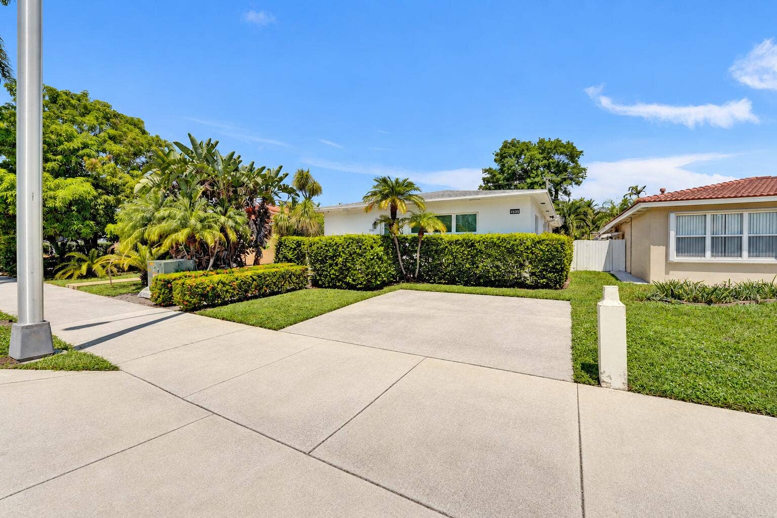 Manicured lawn with mature landscaping, providing a lush exterior