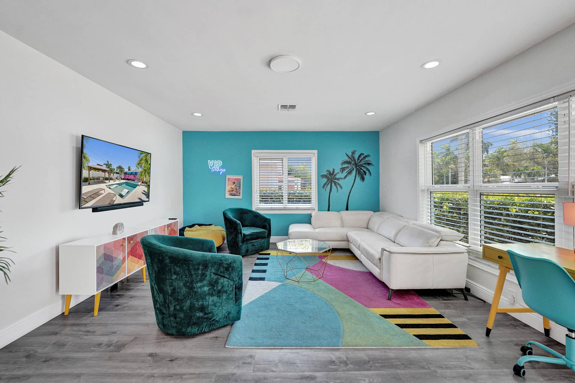 Recessed lighting, wood-finish flooring, and multiple windows with blinds