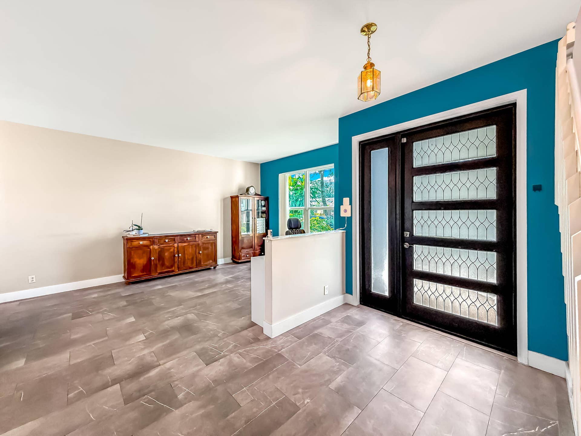 18980 CONCERTO Drive, Boca Raton, FL 33498 Entryway featuring a dark wood door with decorative glass panels, a side light, and a brass-tone pendant light