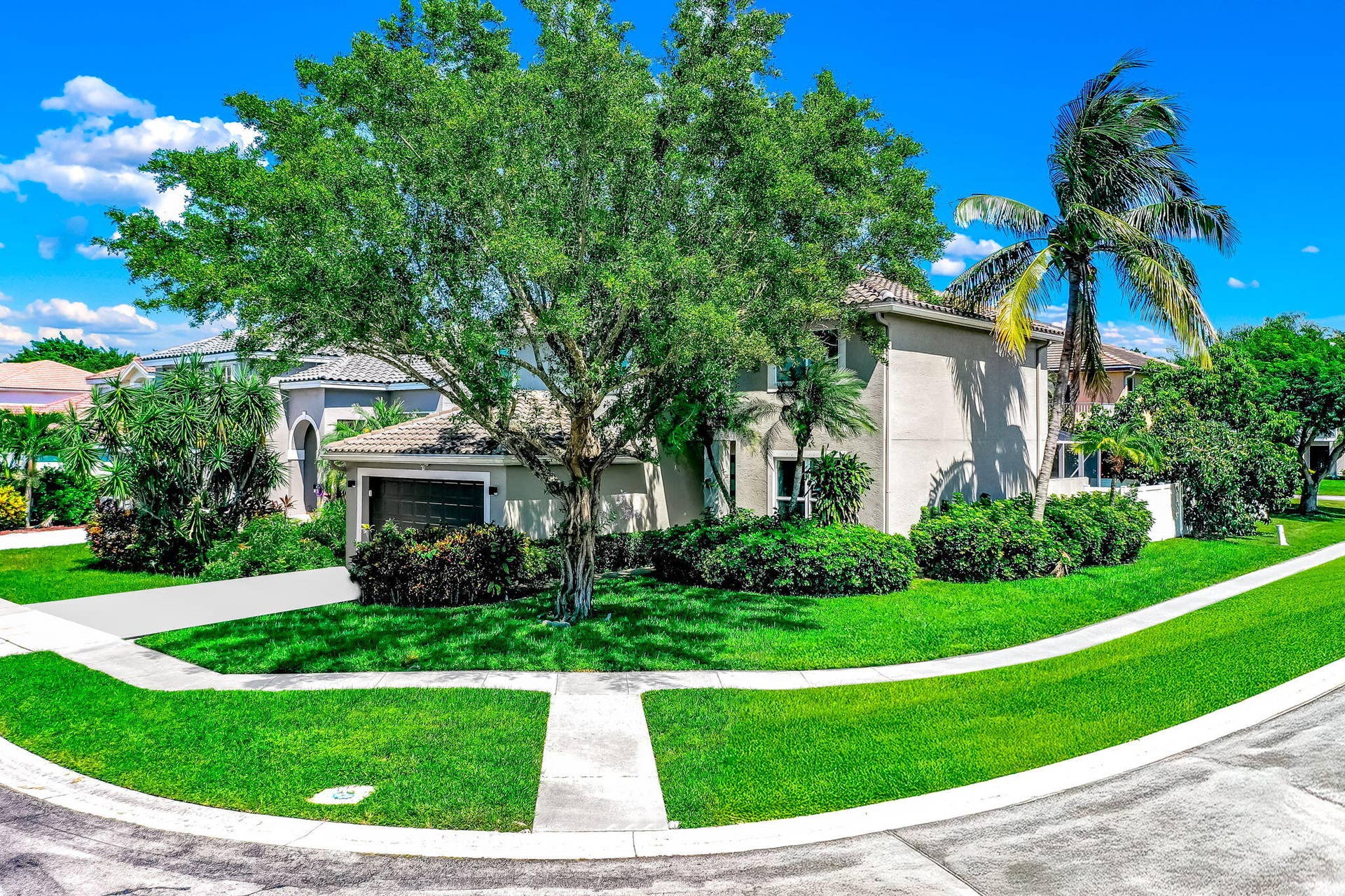 18980 CONCERTO Drive, Boca Raton, FL 33498 Stucco exterior with a tile roof, an integrated garage, a concrete driveway, and established landscaping