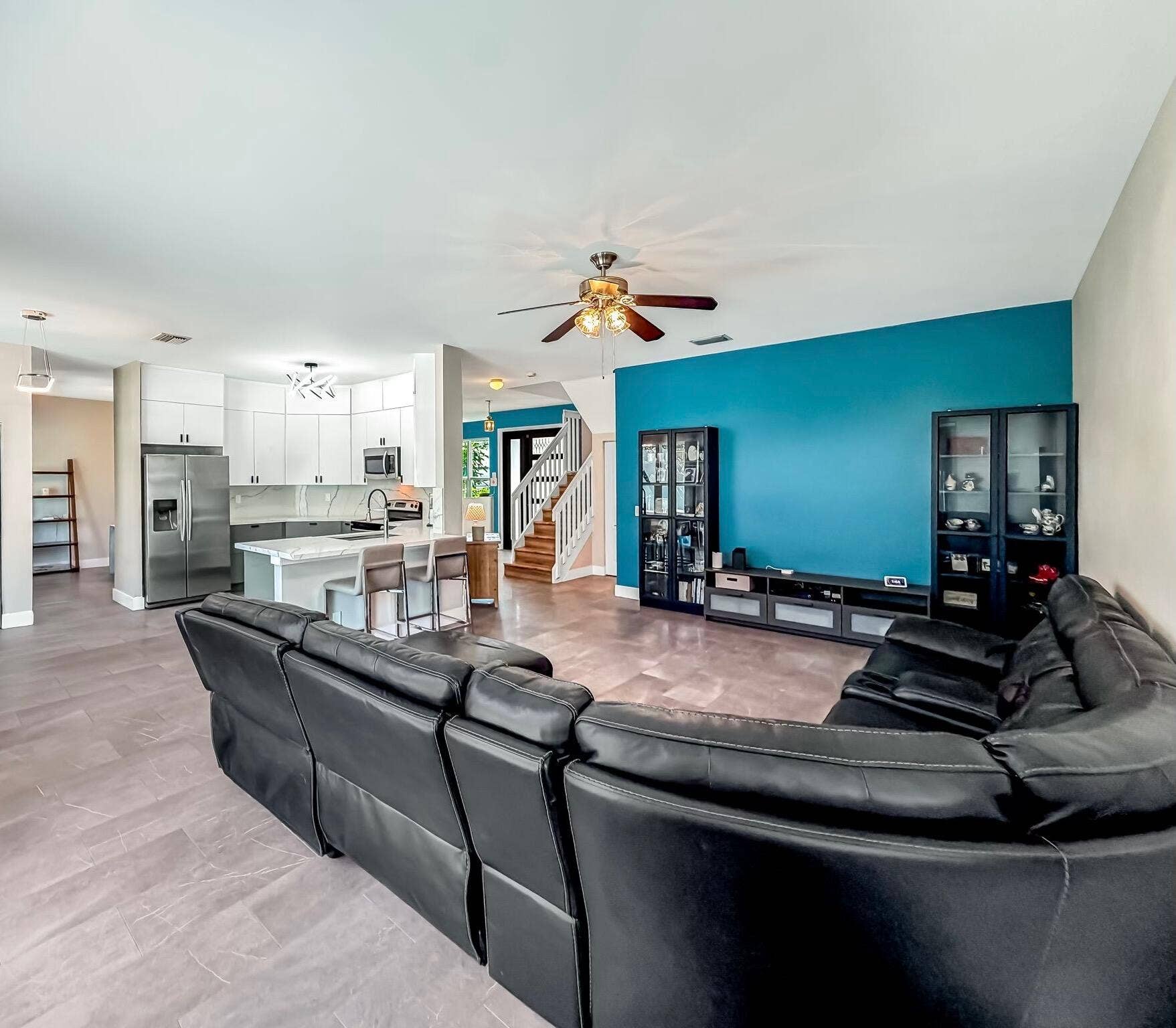 18980 CONCERTO Drive, Boca Raton, FL 33498 Expansive great room featuring large format tile flooring, a ceiling fan with integrated lighting, and multiple windows
