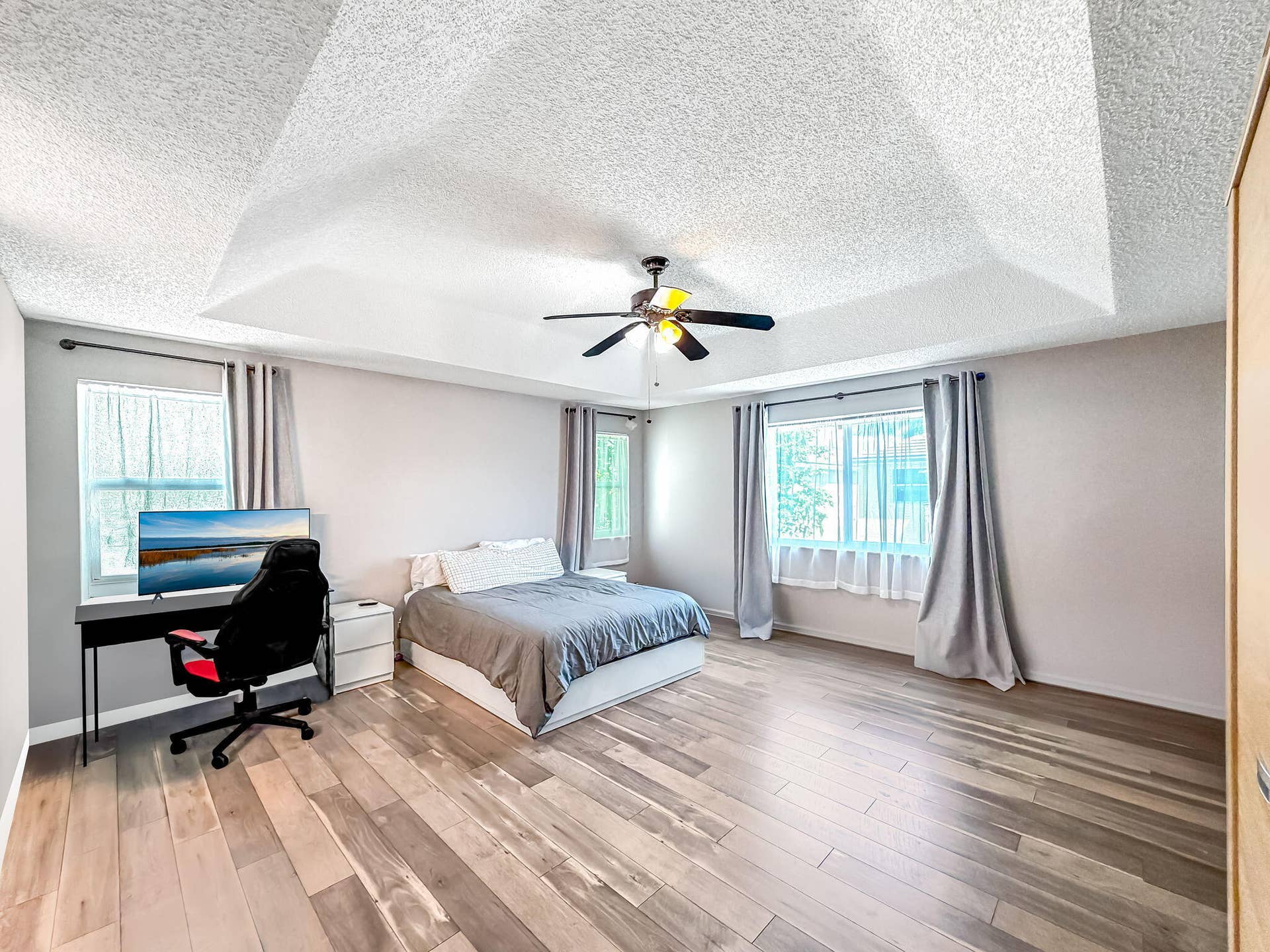 18980 CONCERTO Drive, Boca Raton, FL 33498 Tray ceiling with integrated lighting, wood-finish flooring, and multiple windows