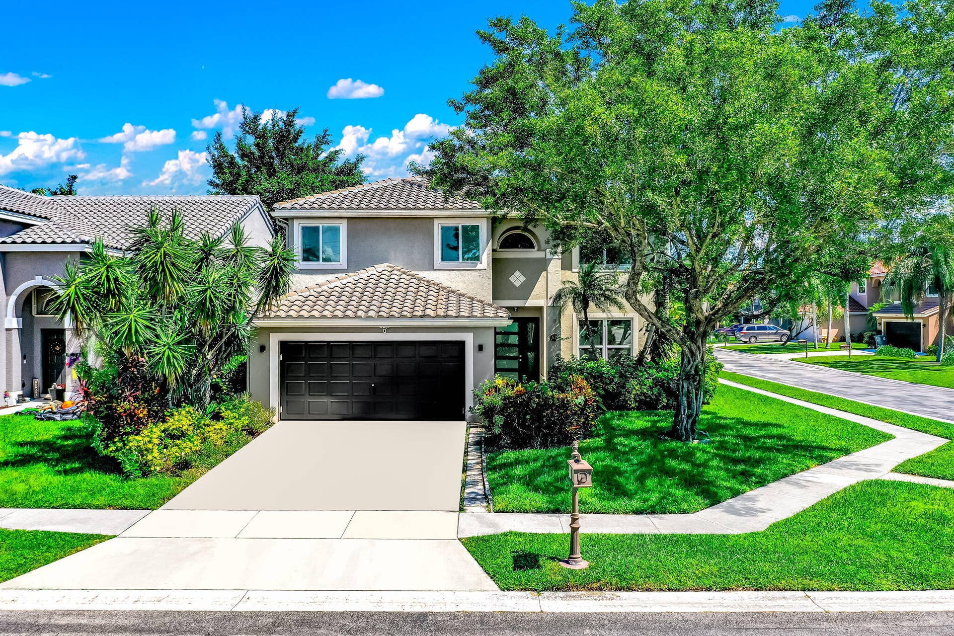 18980 CONCERTO Drive, Boca Raton, FL 33498 Two-story stucco exterior with a tiled roof, integrated garage, and a concrete driveway