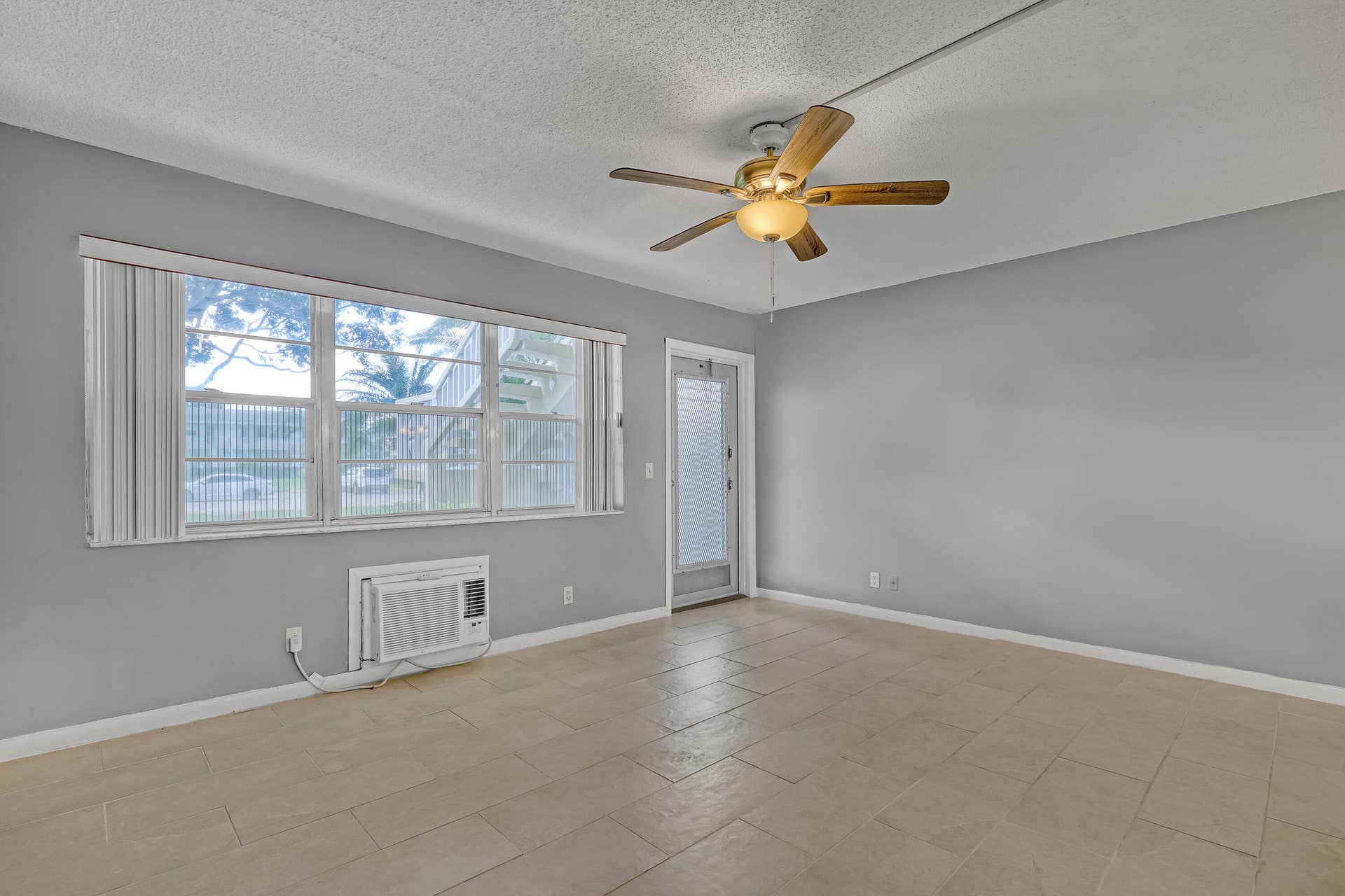 Large windows bring in natural light, and the ceiling fan helps keep you cool.