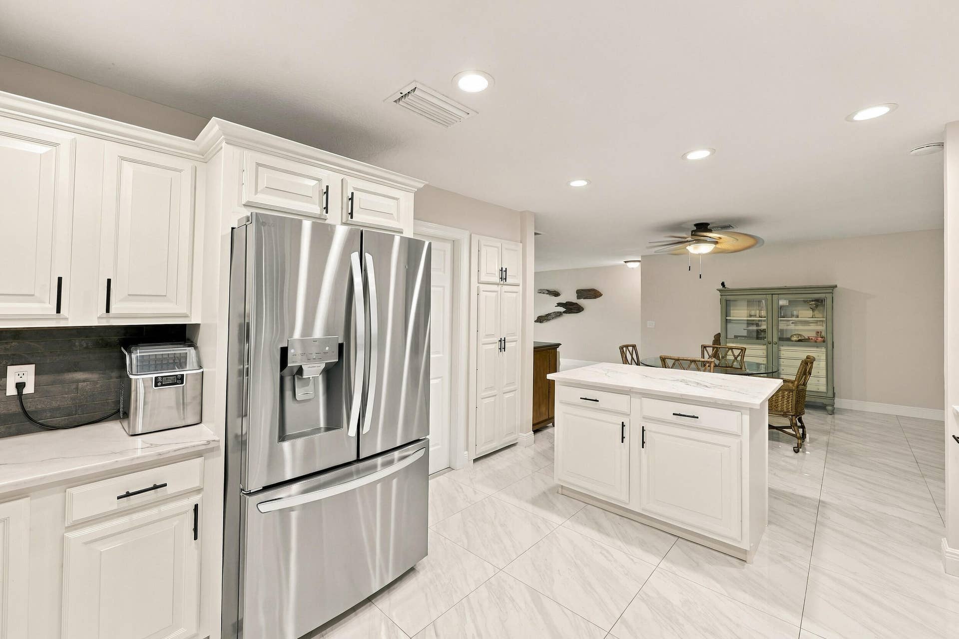 3590 Lakeview Drive, Delray Beach, FL 33445 The impeccably upgraded kitchen offers white cabinetry, quartz countertops, stainless steel appliances, and a beautiful charcoal backsplash. There is tons of storage and counter space for even the most discerning chef.