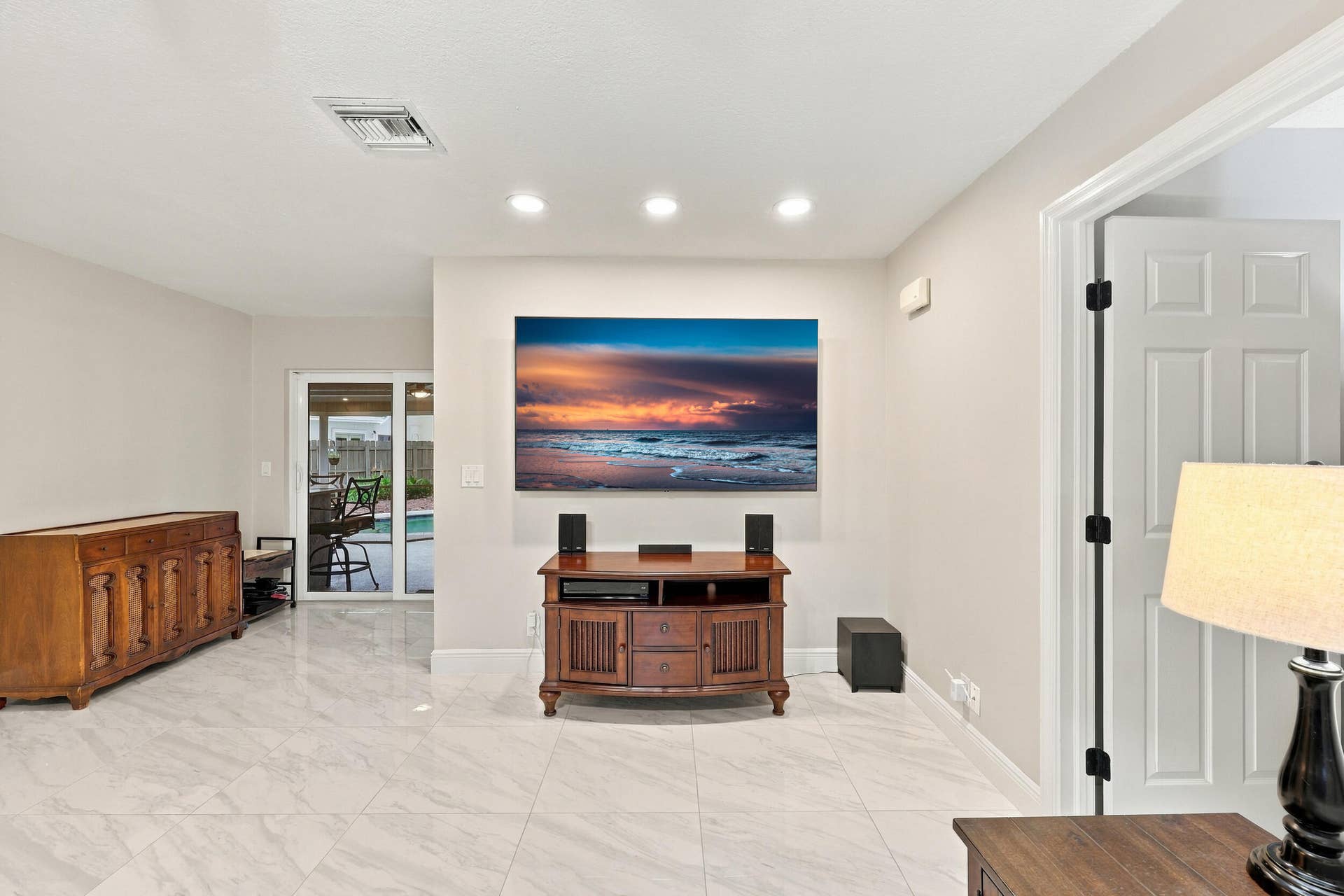 3590 Lakeview Drive, Delray Beach, FL 33445 The family room is a versatile space for children of all ages. Relax and enjoy a separate area away from the kitchen and formal living room that also provides direct access through sliding glass doors to the covered patio and one-of-a-kind backyard.