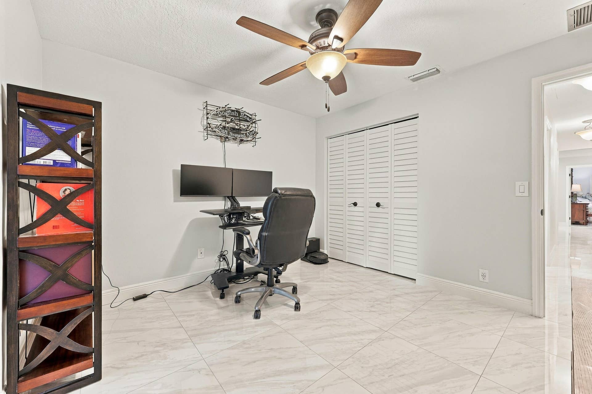 3590 Lakeview Drive, Delray Beach, FL 33445 Guest bedroom 2 is spacious, with an abundance of natural light coming through the hurricane-impact French doors that lead to the 900-square-foot covered and screened-in patio.