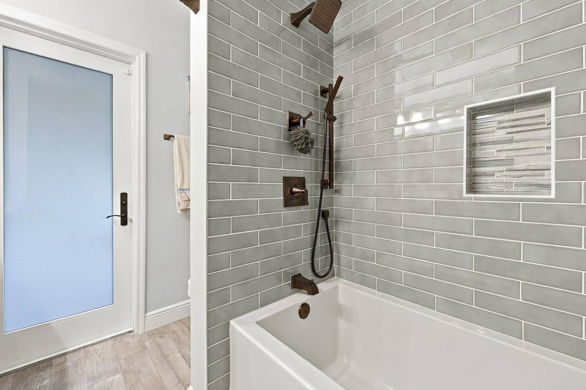 3590 Lakeview Drive, Delray Beach, FL 33445 Bathroom 3 is a fully updated cabana bathroom with a new vanity, countertops, tile, and a tub and shower. Your guests will access it while spending days and evenings in the most beautiful backyard in Delray Beach.
