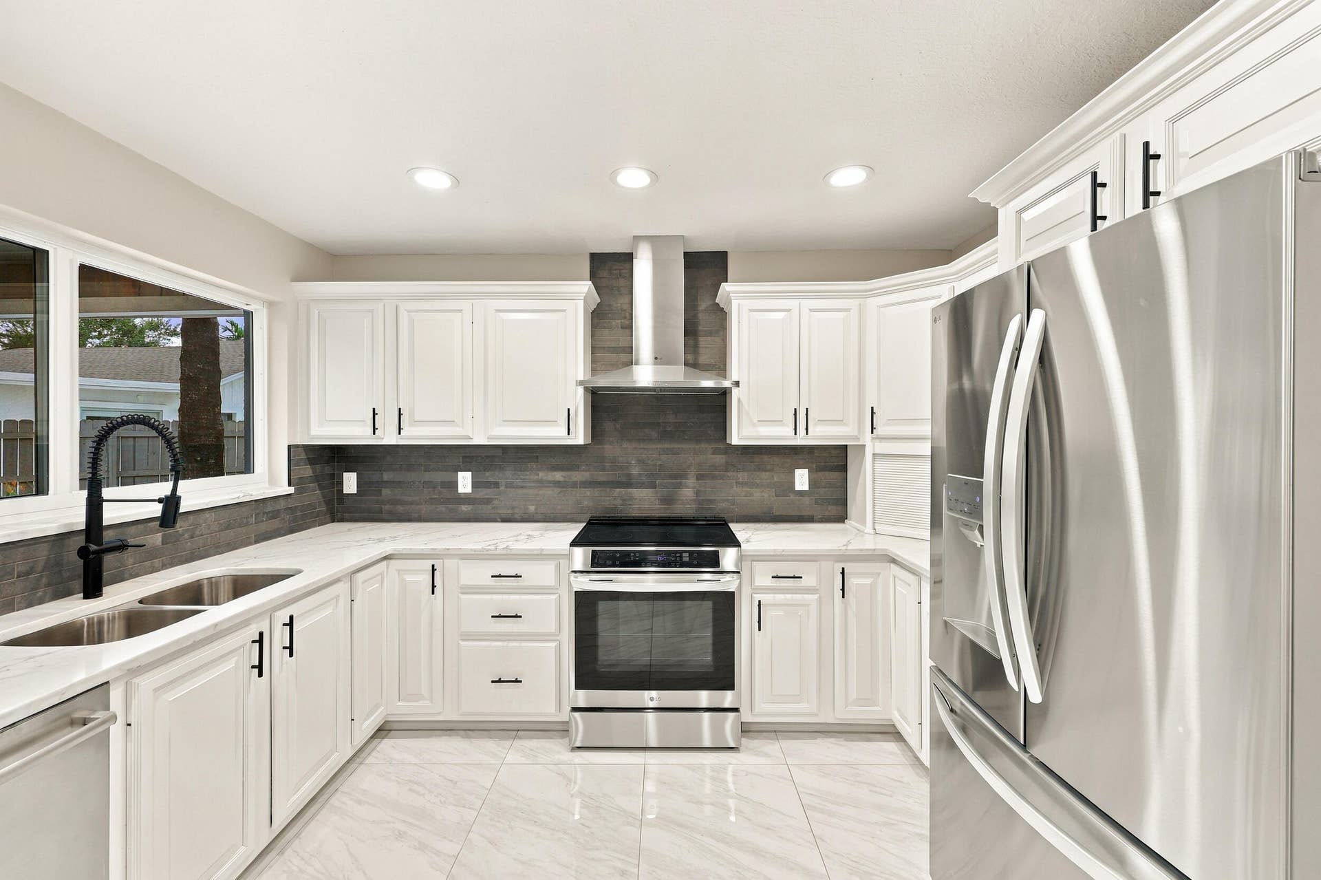 3590 Lakeview Drive, Delray Beach, FL 33445 The impeccably upgraded kitchen offers white cabinetry, quartz countertops, stainless steel appliances, and a beautiful charcoal backsplash. There is tons of storage and counter space for even the most discerning chef.