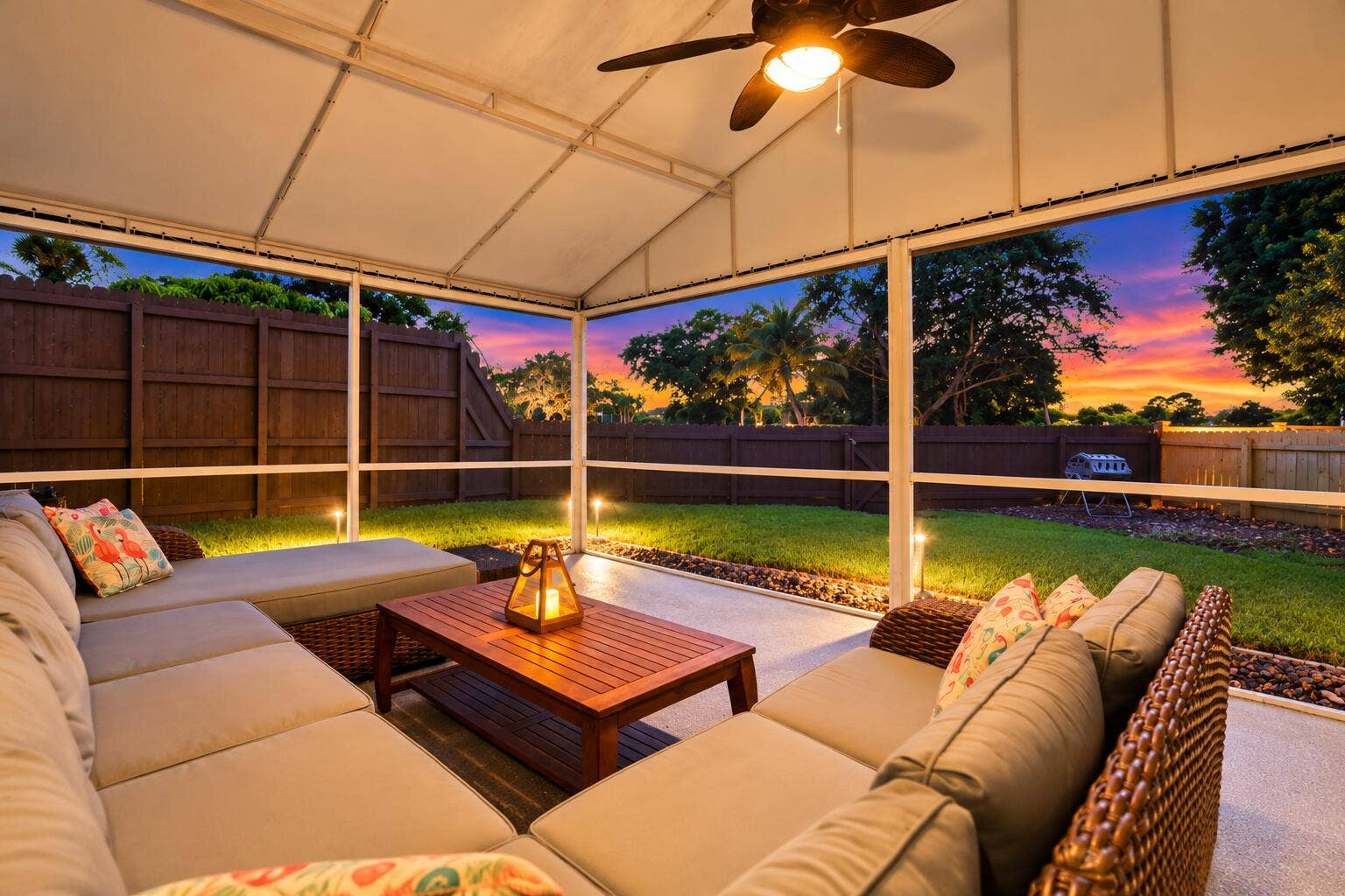 A living room outside is highlighted by vaulted ceilings, a privacy fence, views of Lakeview Golf Course, and a versatile area to entertain.